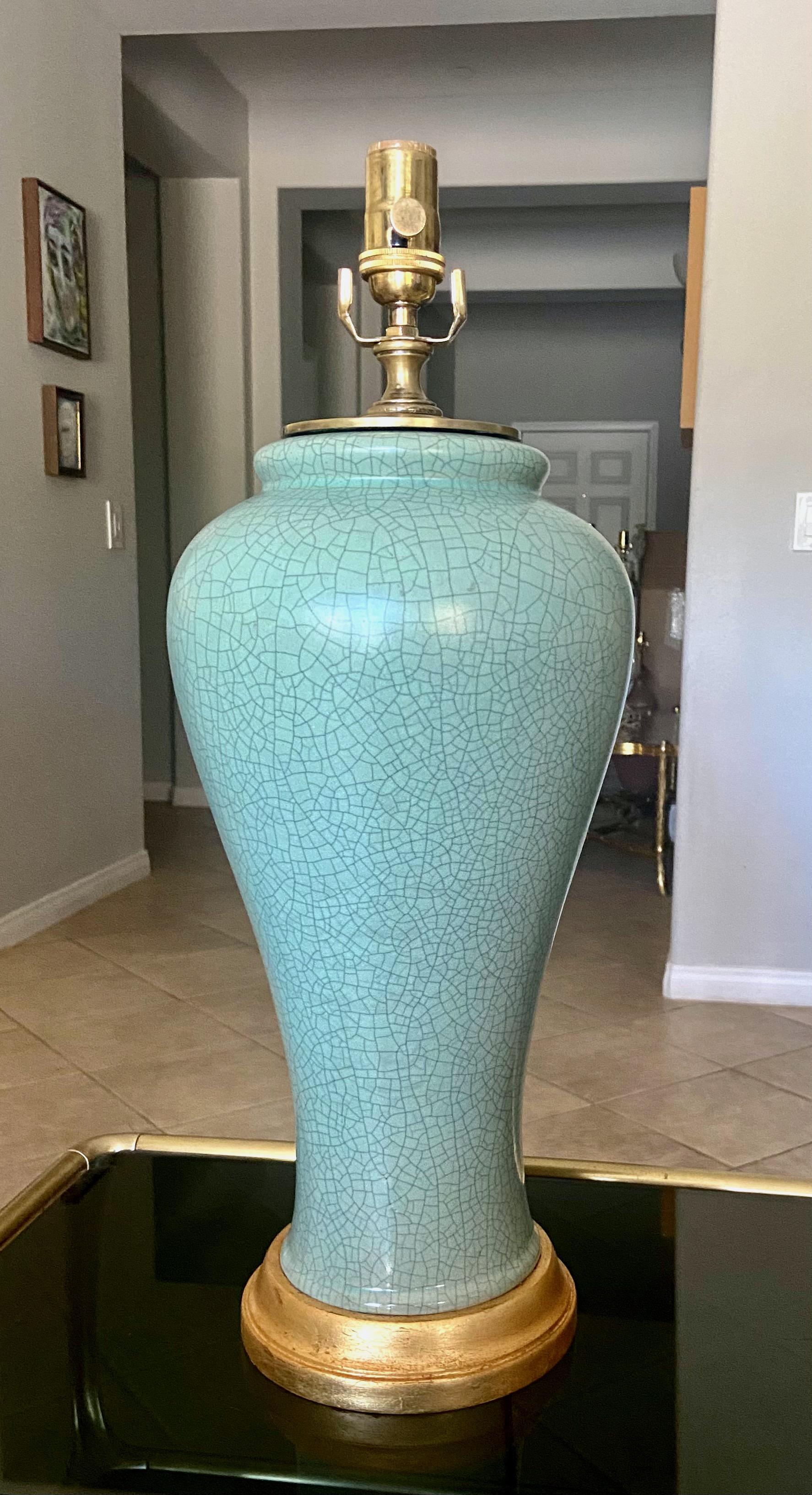 Single Chinese celadon green crackle porcelain baluster form vase table lamp. Mounted on gilt turned wood lamp base. Newly wired with new 3 way socket and fittings. Porcelain vase portion is 16