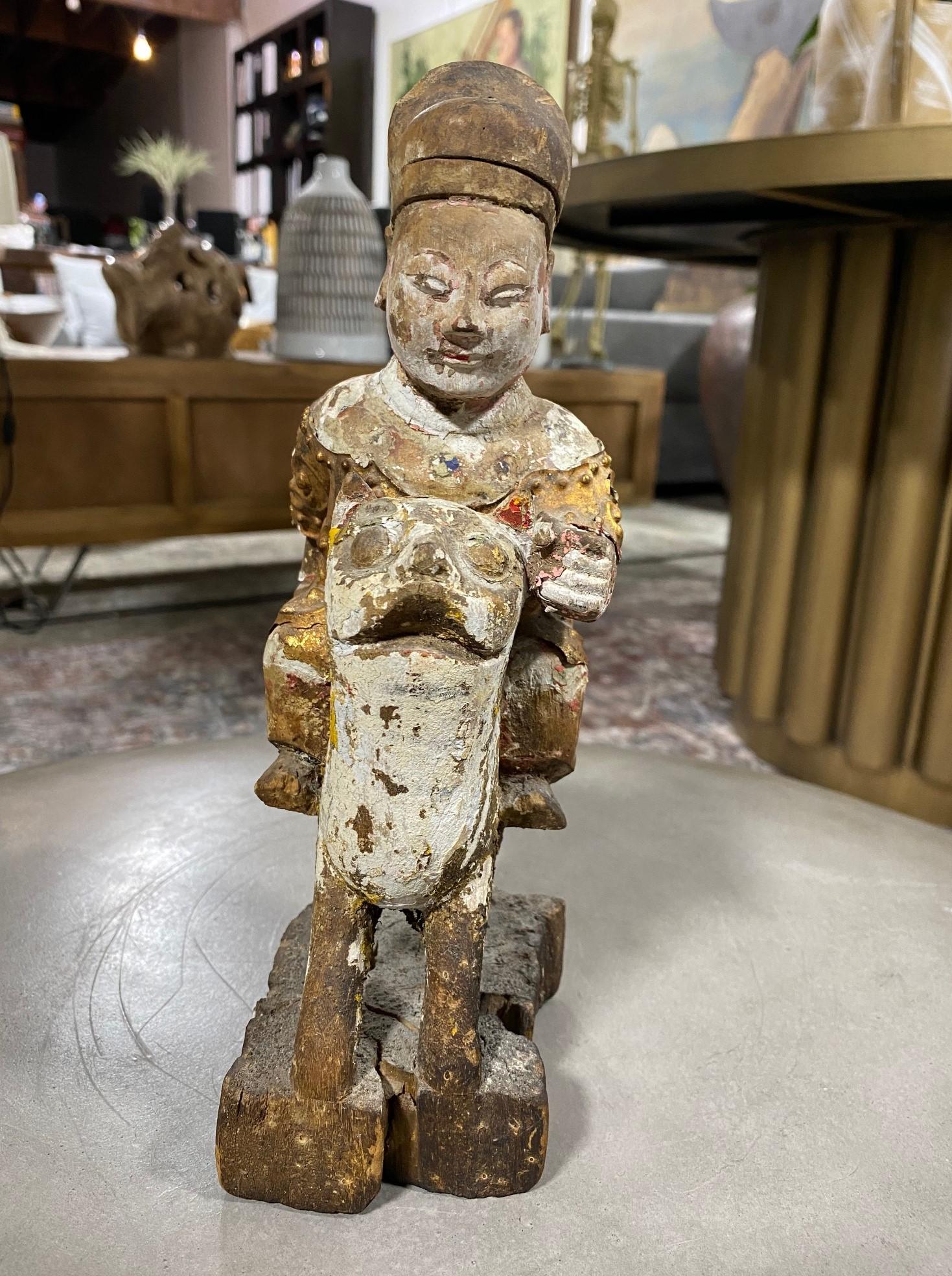 A fantastic wood and gilt decorated hand carved Chinese ancestral temple shrine Emperor figure riding a mythical beast - perhaps a tiger. 

From a collection of Chinese and Asian artifacts. 

We are listing it as 19th century but could be