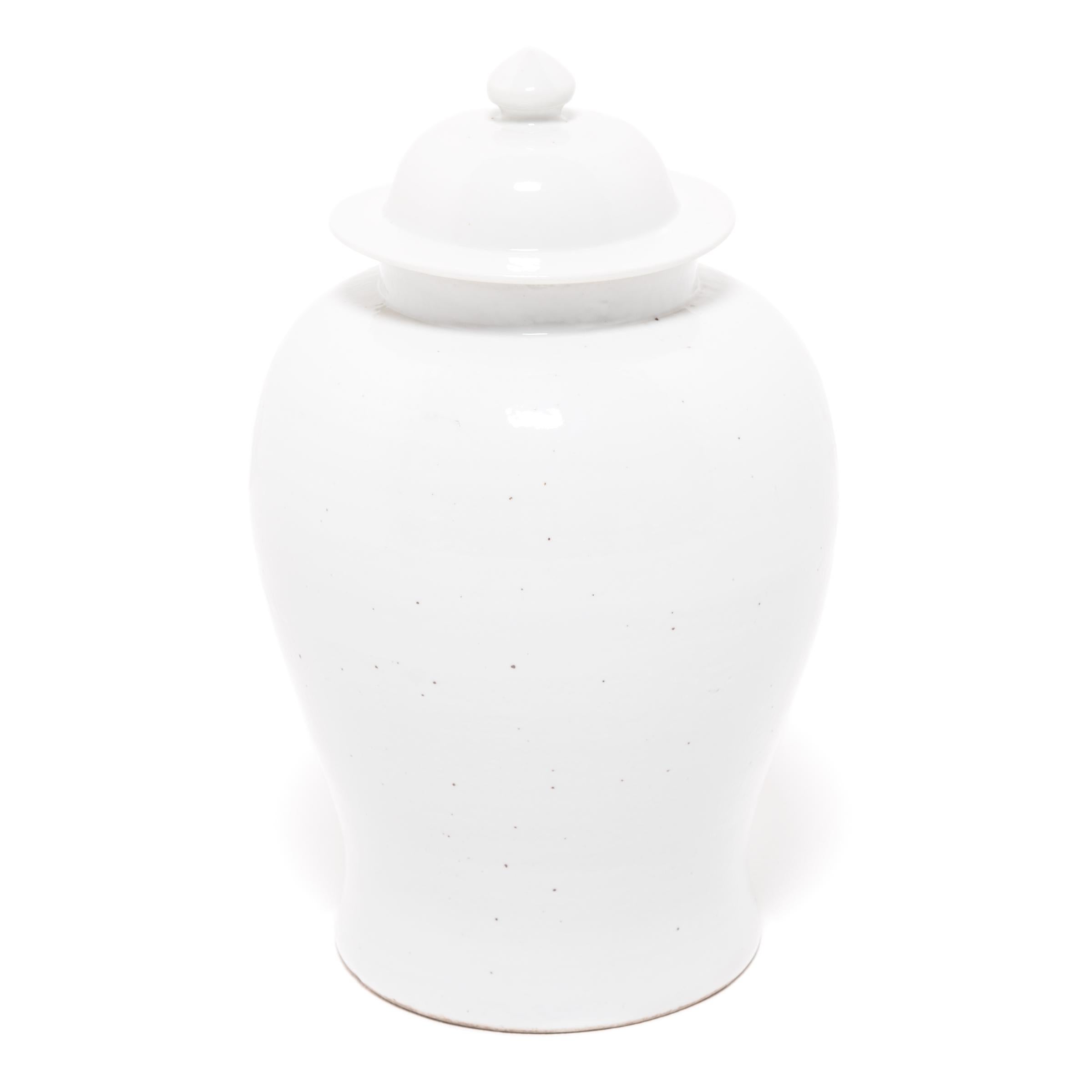 Defined by its rounded body, high shoulders and domed lid, the time-honored look of the Chinese baluster jar takes on a streamlined look in this contemporary interpretation created in Jiangxi province. Once elaborately decorated, this modern take is