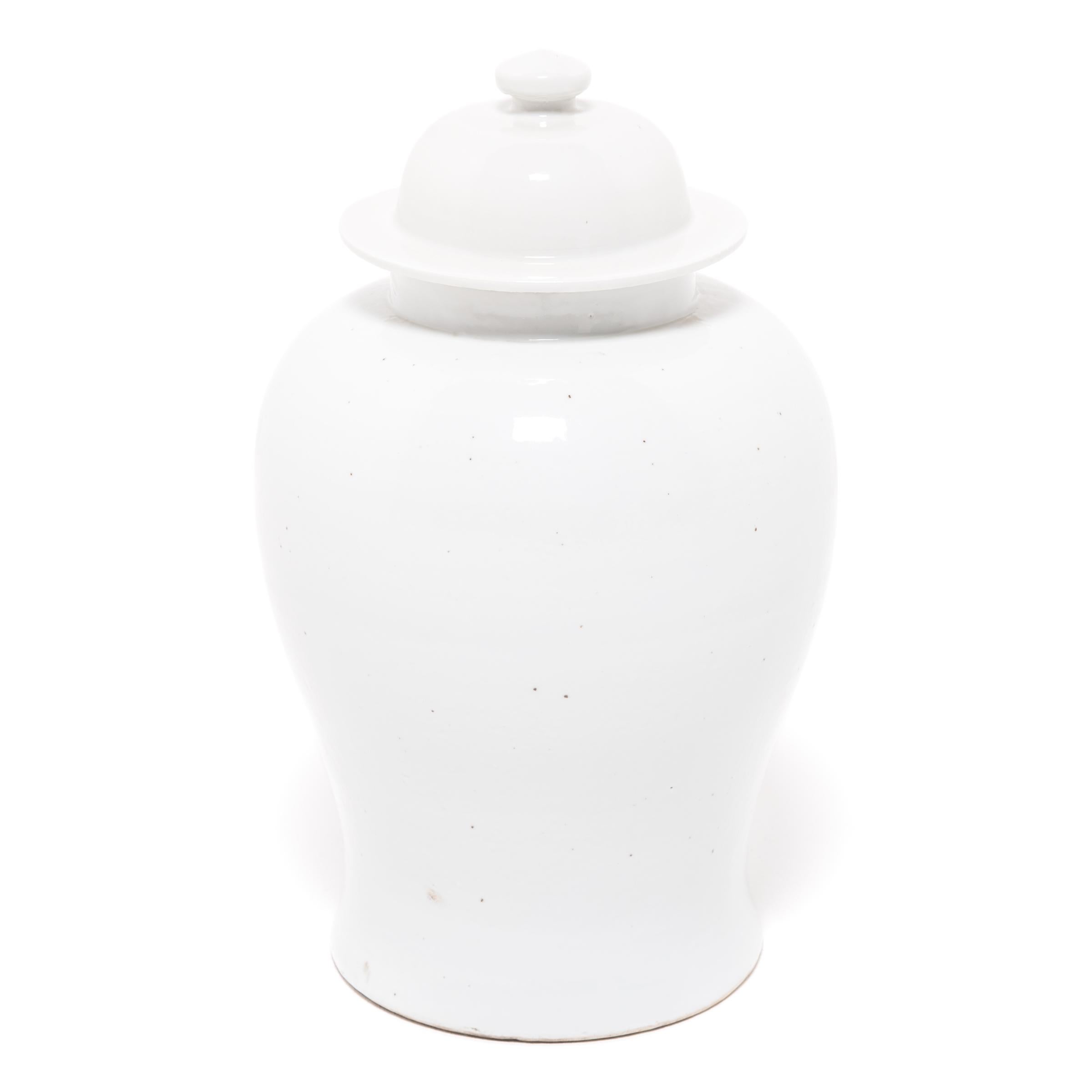 Defined by its rounded body, high shoulders and domed lid, the time-honored look of the Chinese baluster jar takes on a streamlined look in this contemporary interpretation created in Jiangxi province. Once elaborately decorated, this modern take is