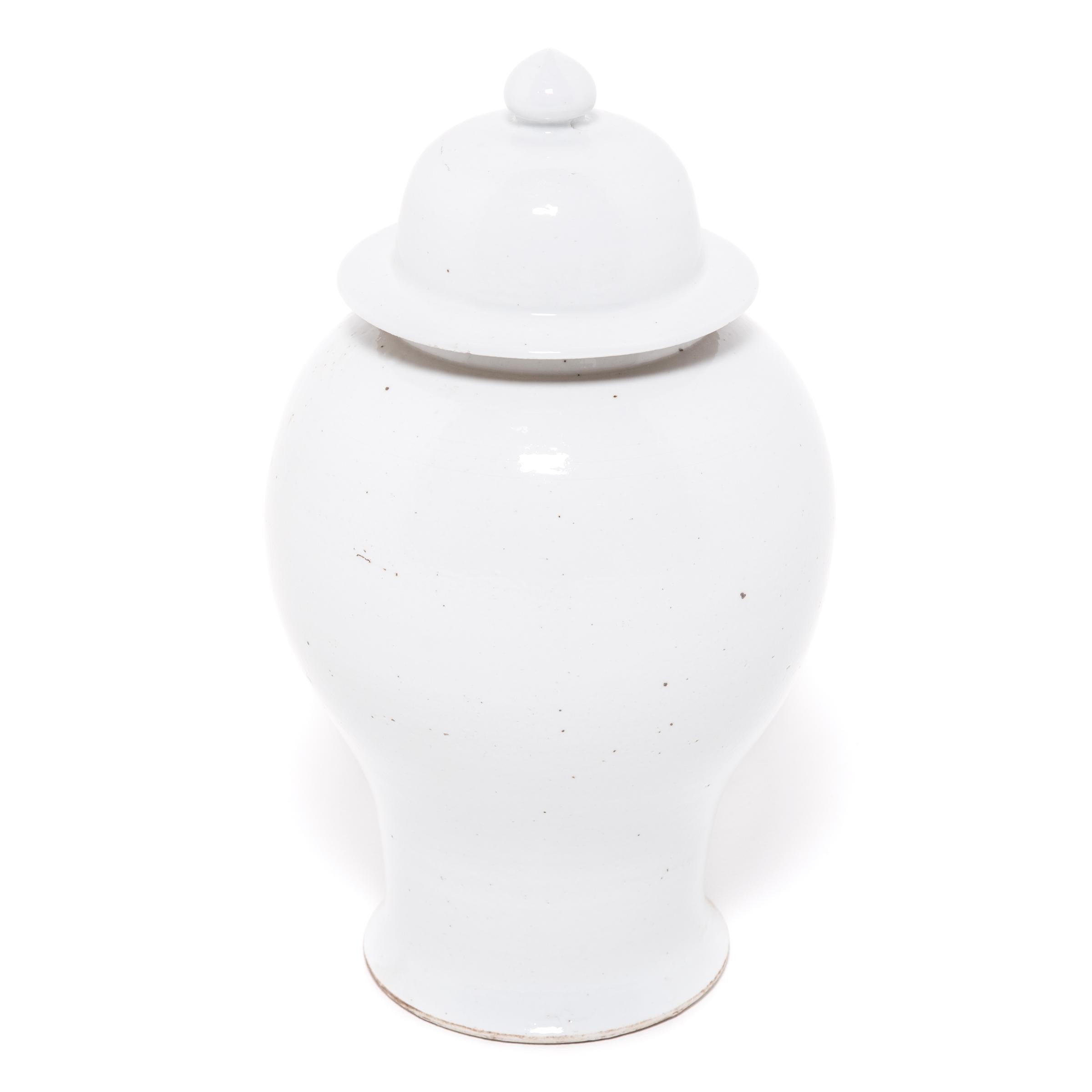 Defined by its rounded body, high shoulders, and domed lid, the time-honored Chinese baluster jar takes on a streamlined look in this contemporary interpretation made in Zhejiang province. Traditionally elaborately decorated, this modern take is
