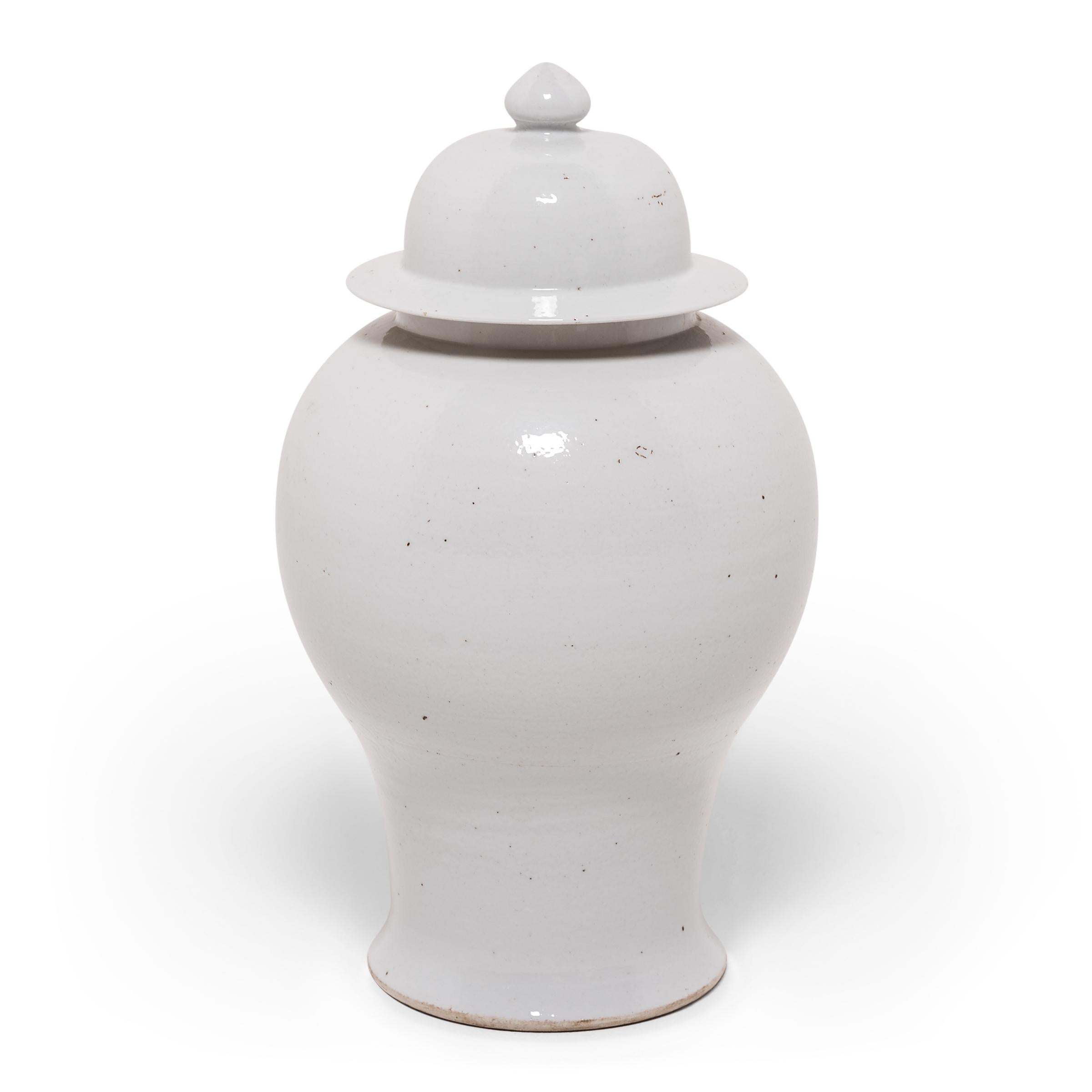 Defined by its rounded body, high shoulders, and domed lid, the time-honored Chinese baluster jar takes on a streamlined look in this contemporary interpretation made in Zhejiang province. Traditionally elaborately decorated, this modern take is