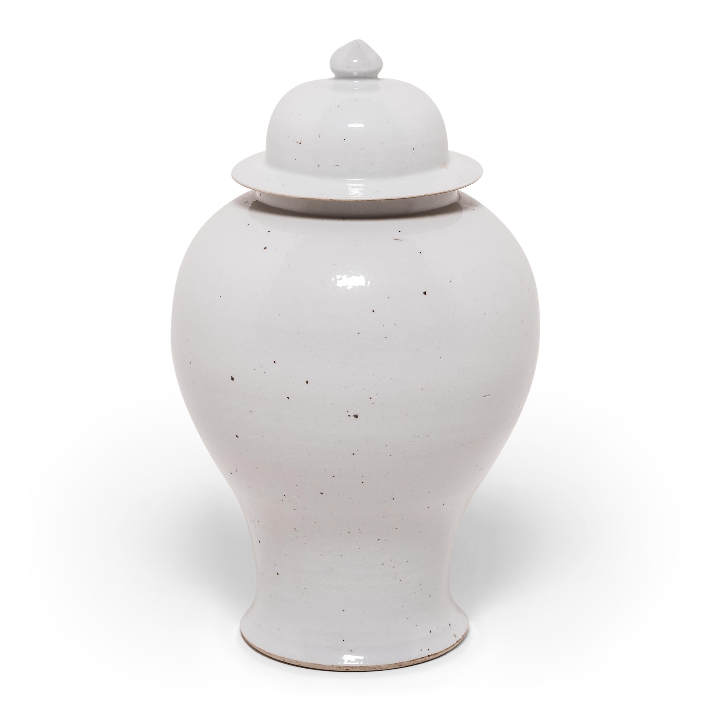 This contemporary take on the traditional ginger jar puts all the focus on the timeless Silhouette. Characterized by its rounded body, high shoulders, and domed lid, the elegant ginger jar form is accentuated here with a clean, white monochromatic