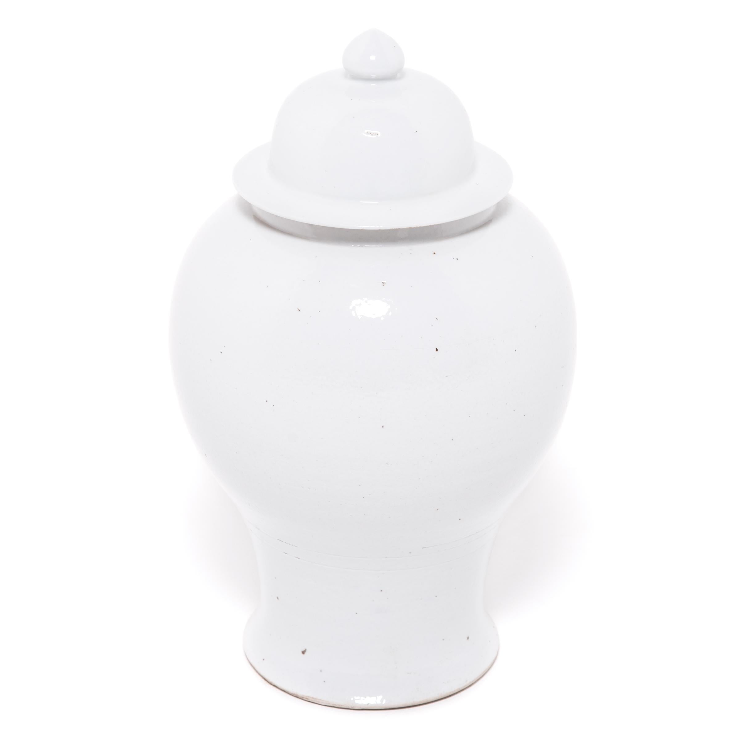 Defined by its rounded body, high shoulders and domed lid, the time-honored look of the Chinese baluster jar takes on a streamlined look in this contemporary interpretation made in Jiangxi province. Traditionally elaborately decorated, this modern