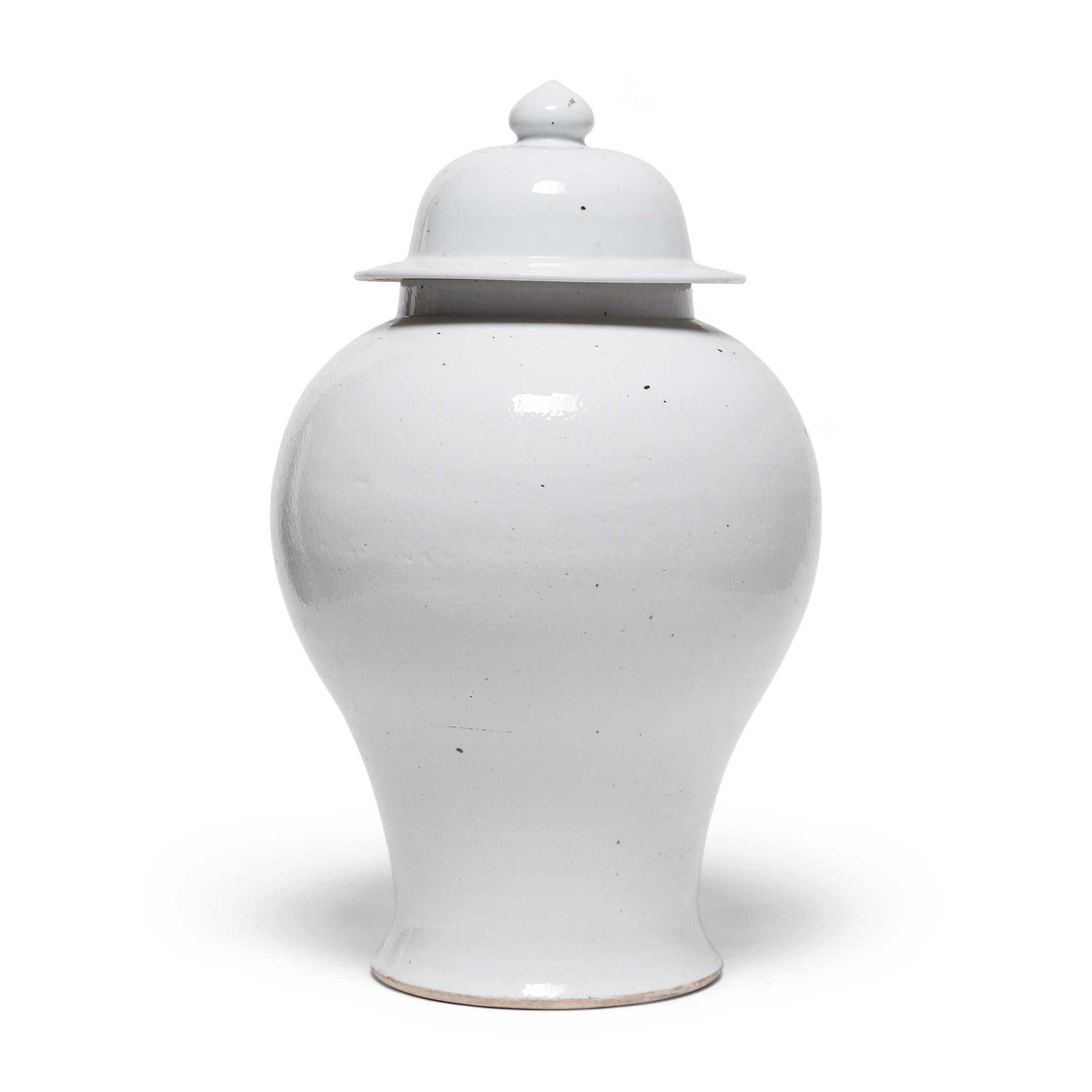 Defined by its rounded body, high shoulders, and domed lid, the time-honored baluster jar form takes on a streamlined look in this modern interpretation. Traditionally elaborately decorated, this contemporary ginger jar is cloaked in a monochrome,