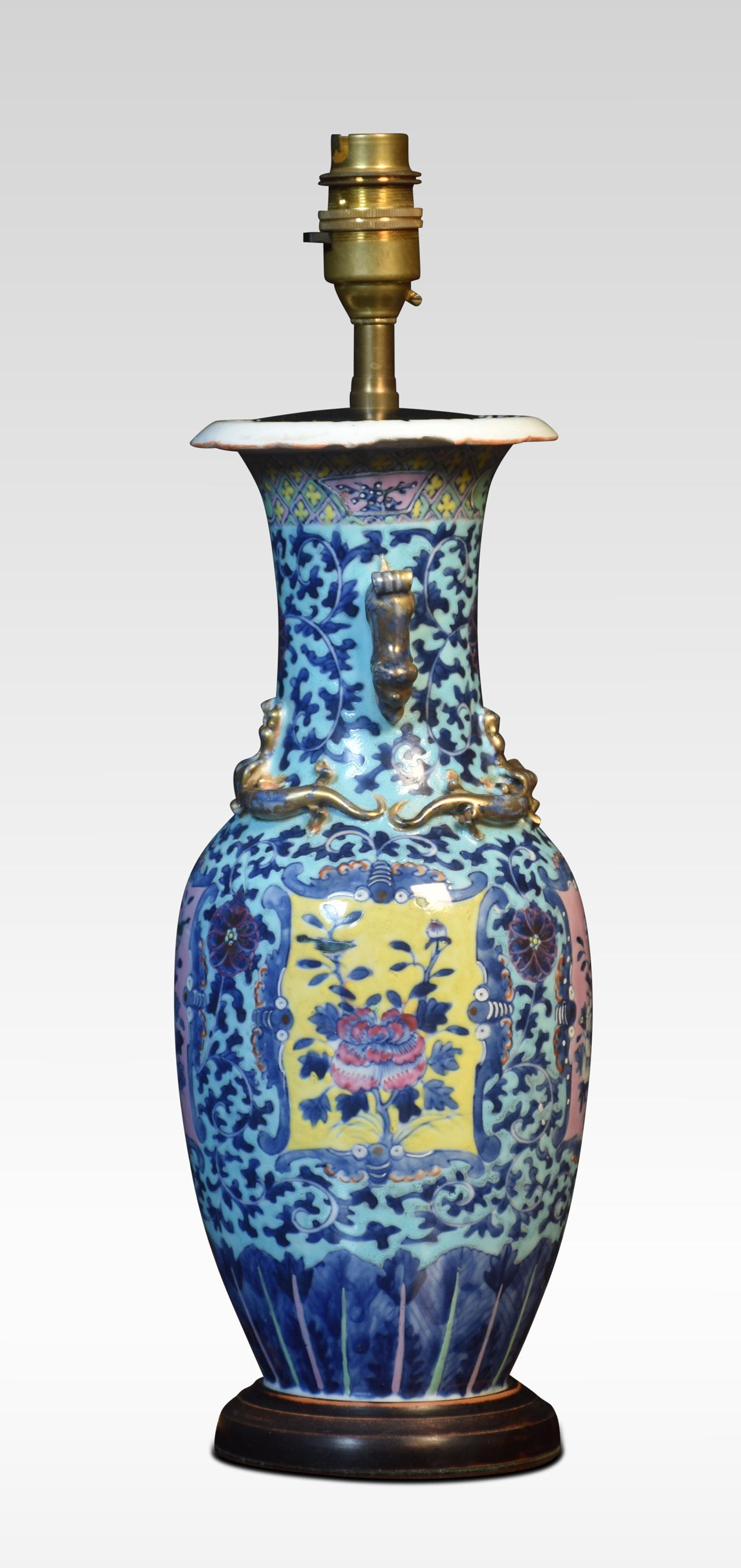 Chinese baluster vase, of blue ground with pink and yellow panels containing flowers, the twin zoomorphic handles to the neck above applied lizards. Converted to a lamp.
Dimensions
Height 16 Inches
Width 5.5 Inches
Depth 5.5 Inches.