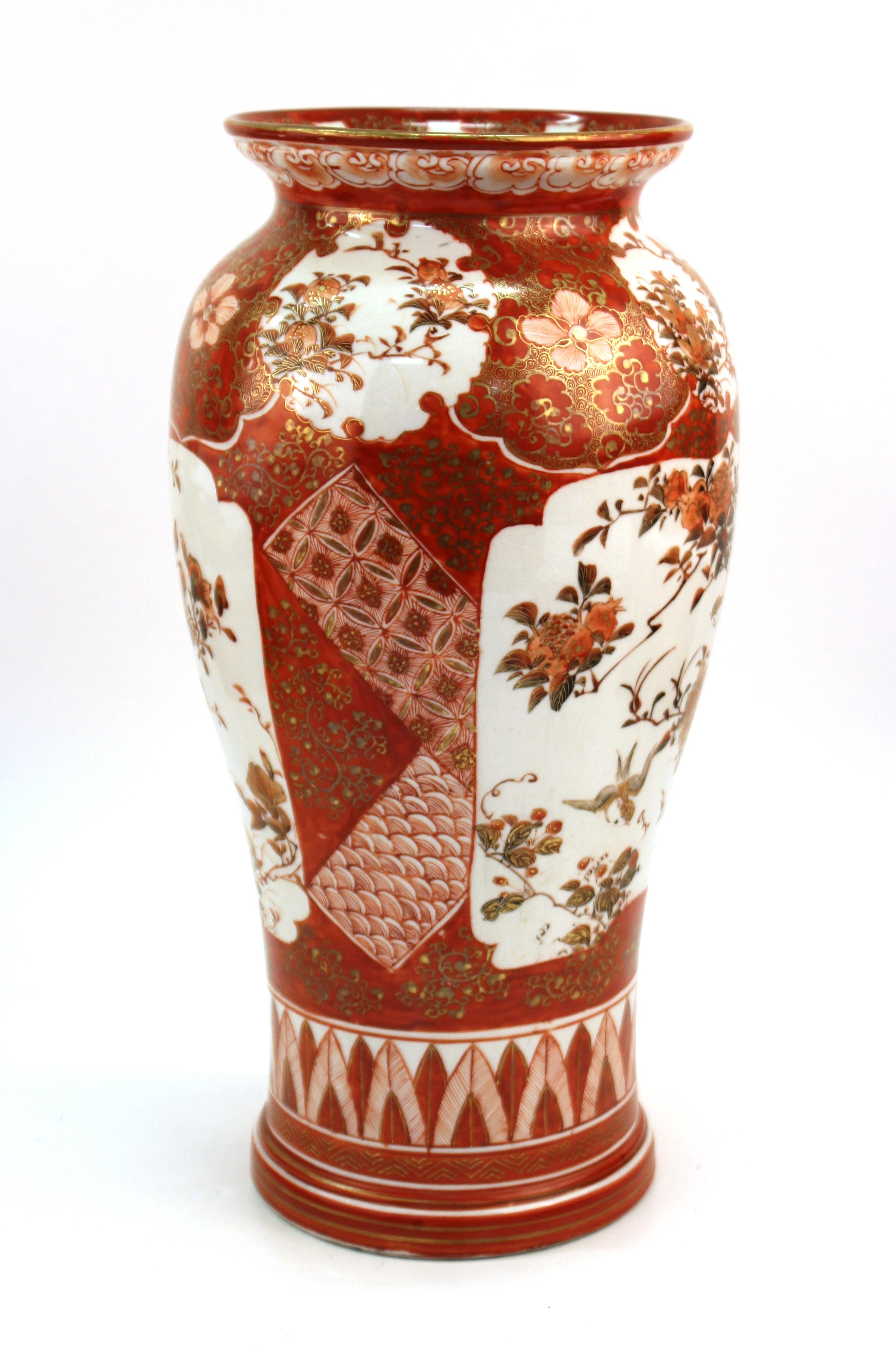 Japanese Kutani ware porcelain baluster shape vase in red with floral decor and geometric band on the base. This piece dates from the Meiji period (between 1880-1900). The piece has a hole in the bottom, likely due to a previous use as a table lamp.