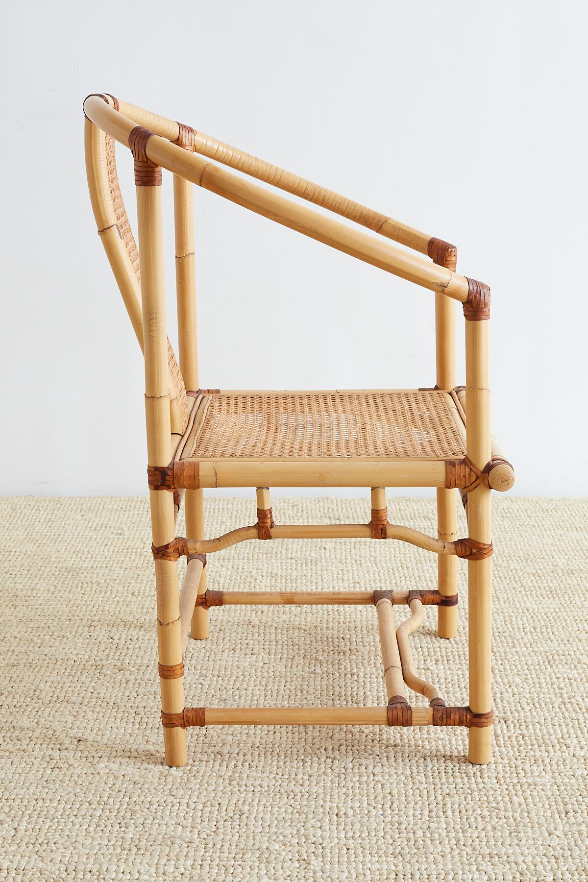 Chic Chinese style bamboo and cane horseshoe armchair featuring a light blonde bent rattan frame. Produced by Anita Vira Andika in Indonesia, probably for Wicker Works in San Francisco, CA. The backsplat and seat have been finished in cane and the