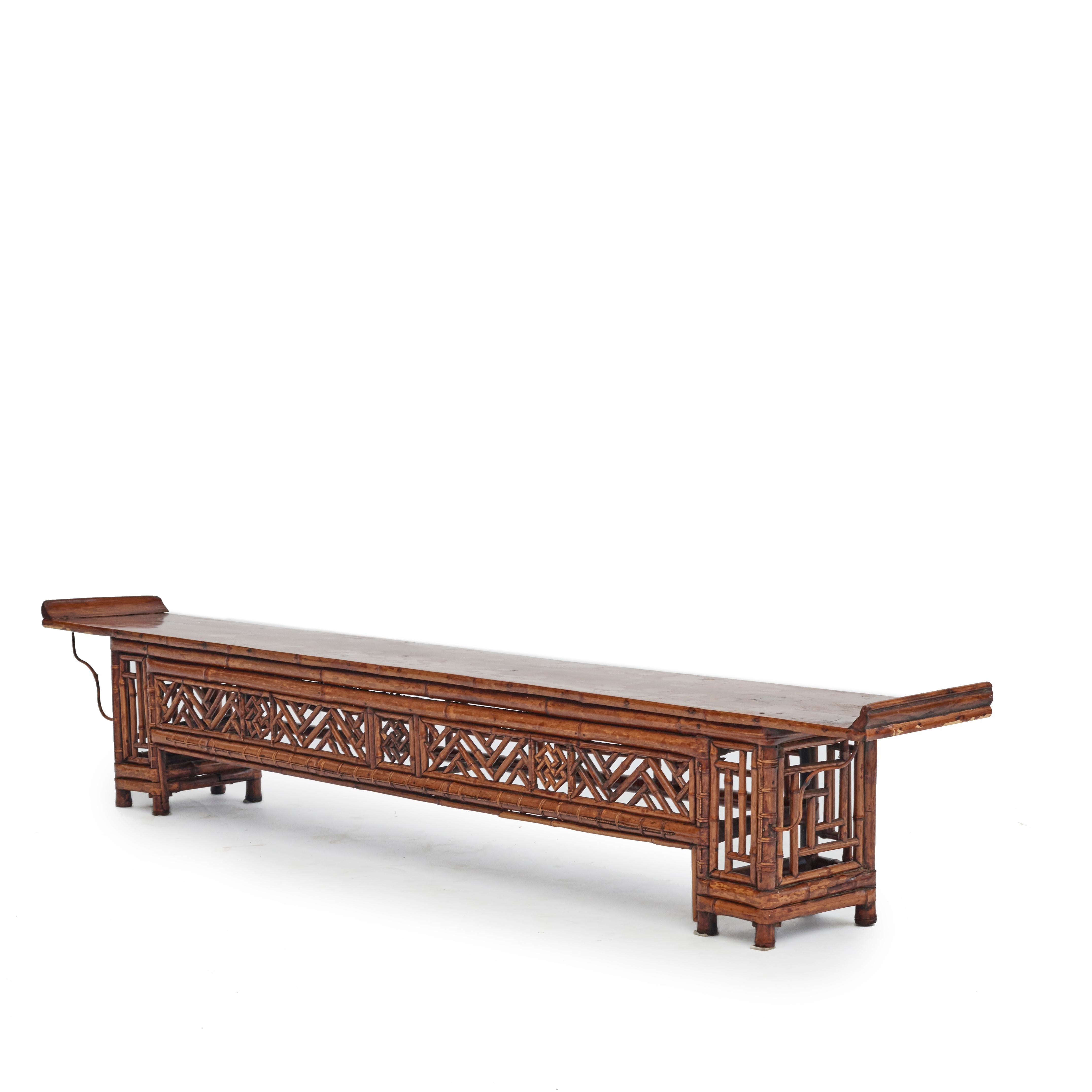 Low qing style console table made of bamboo, table top of elm wood.
Apron and legs with a decor of geometrical Chinese openwork motifs.

Natural age-related beautiful patina.
China, 1840-1860.

Measure : H: 32,5 / 35 cm