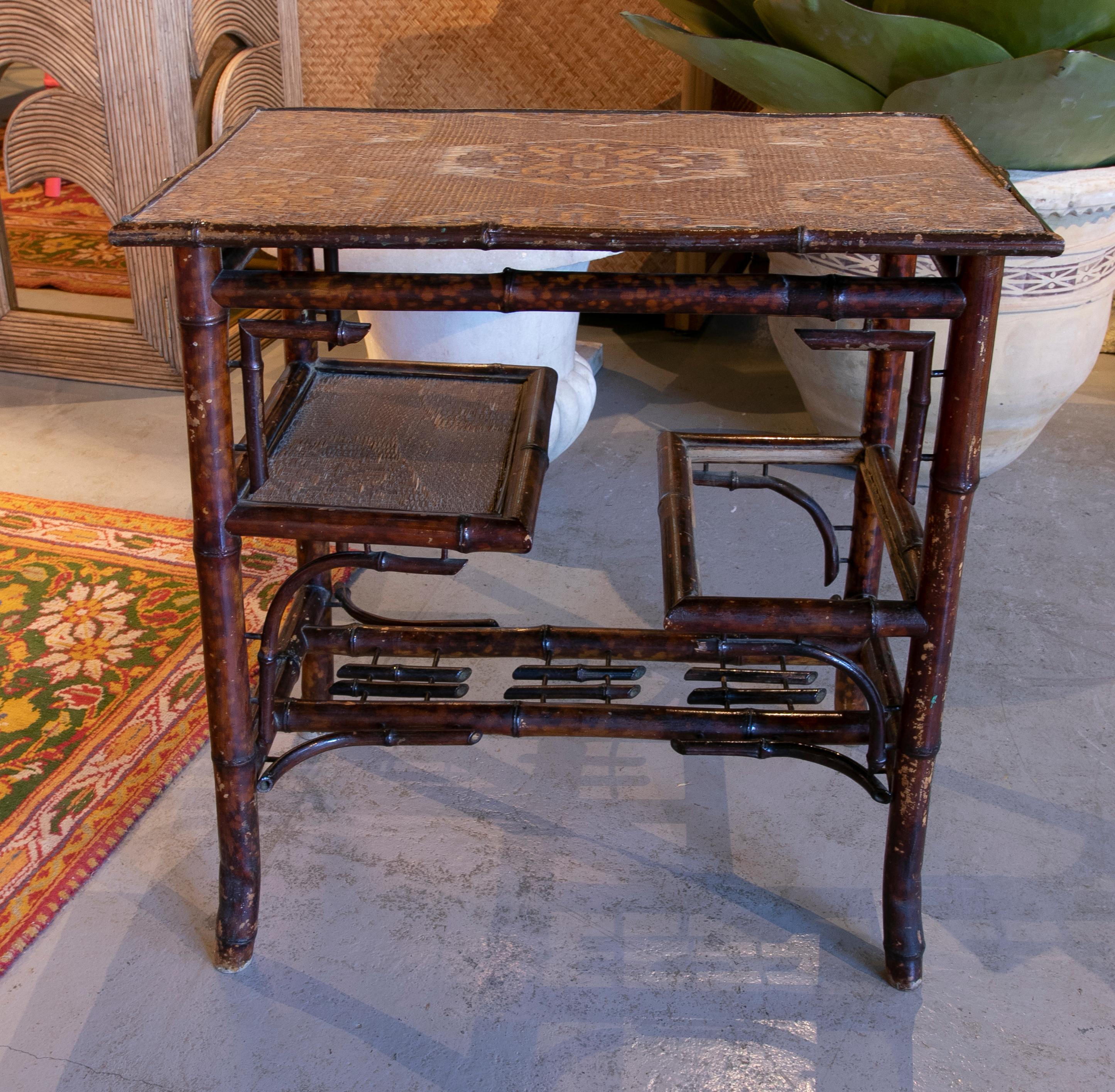 Chinese bamboo sidetable with wicker shelves and top from the 1950ies.