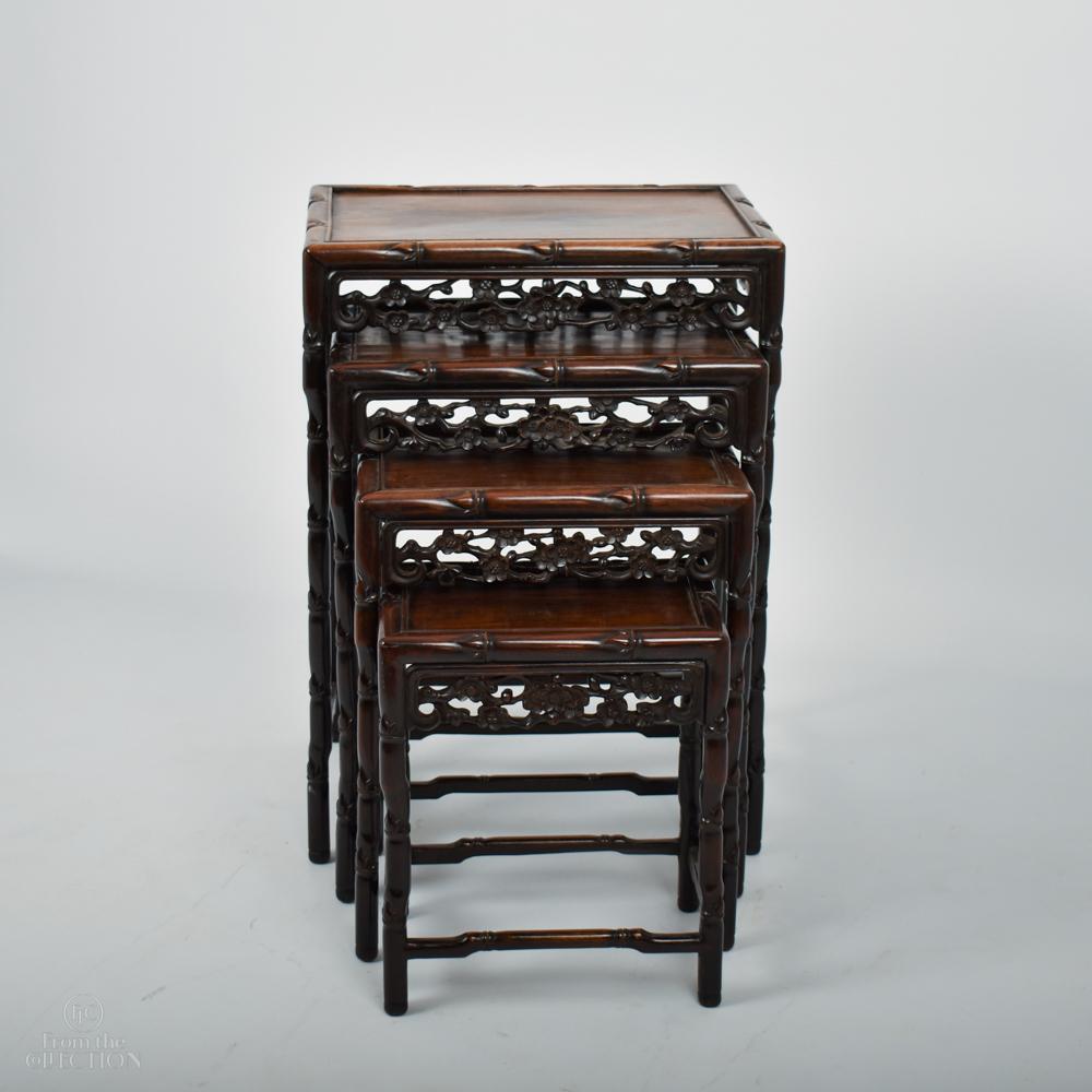 Chinese Bamboo Style Nest of Rosewood Tables circa 1900, with detailed carving around the border to the top of all 4 tables.