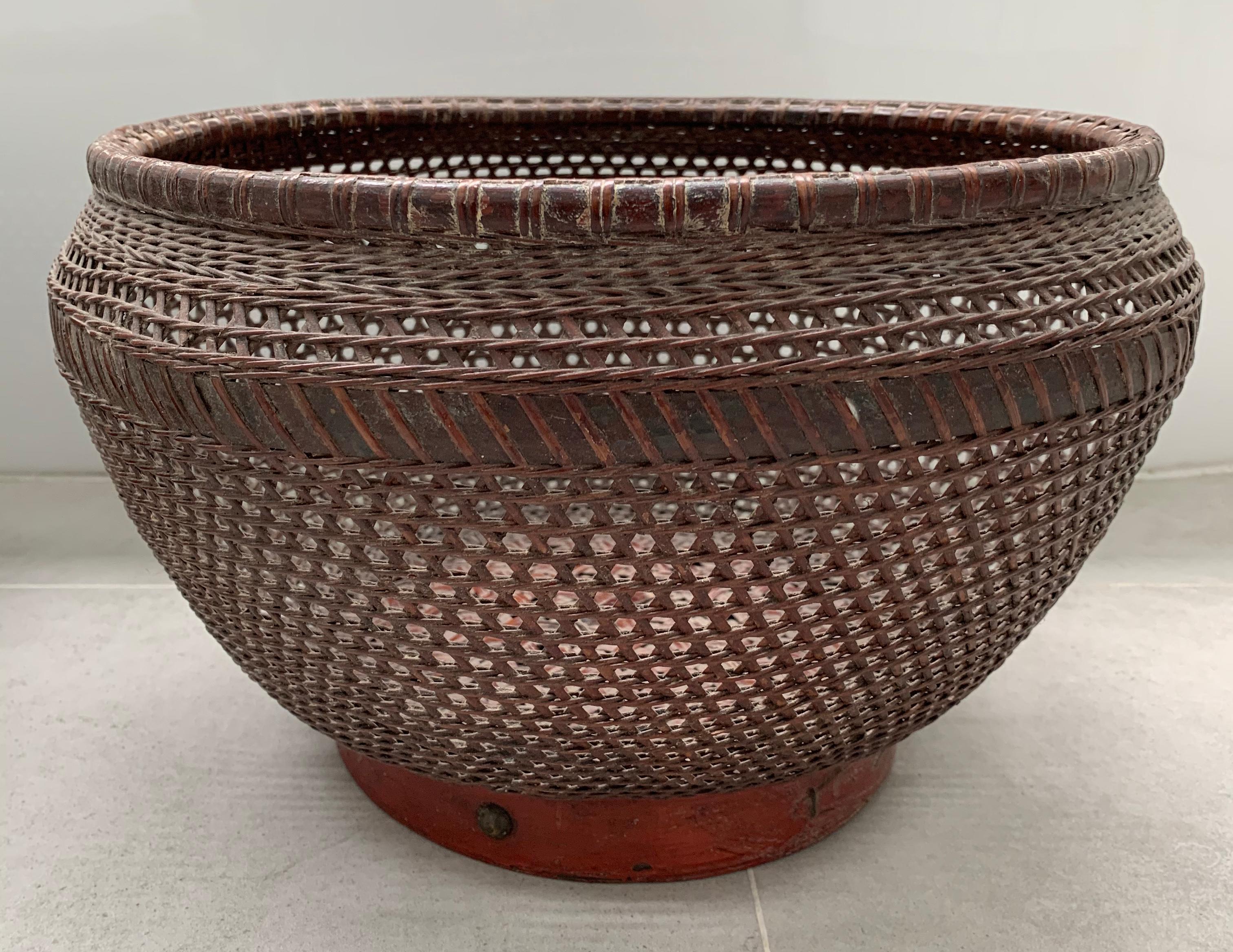 This pair of hand-woven Chinese Baskets feature a red wood lacquered base and brown rattan fibres. Their minimalist design makes them suitable as a decorative addition to any space. 

Dimensions: Depth 30cm x Height 20cm & Depth 32cm x Height 20cm.