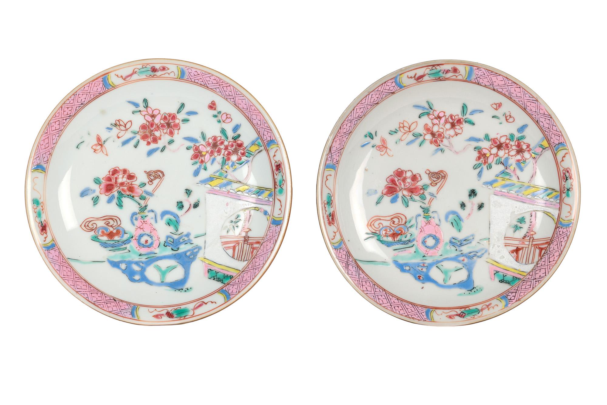 A fine pair Chinese Qianlong porcelain hand painted Batavian saucer dishes in the famille rose palette dating from the 18th century. The finely made dishes are of simple rounded shape standing on a narrow unglazed cut foot with brown glazes applied