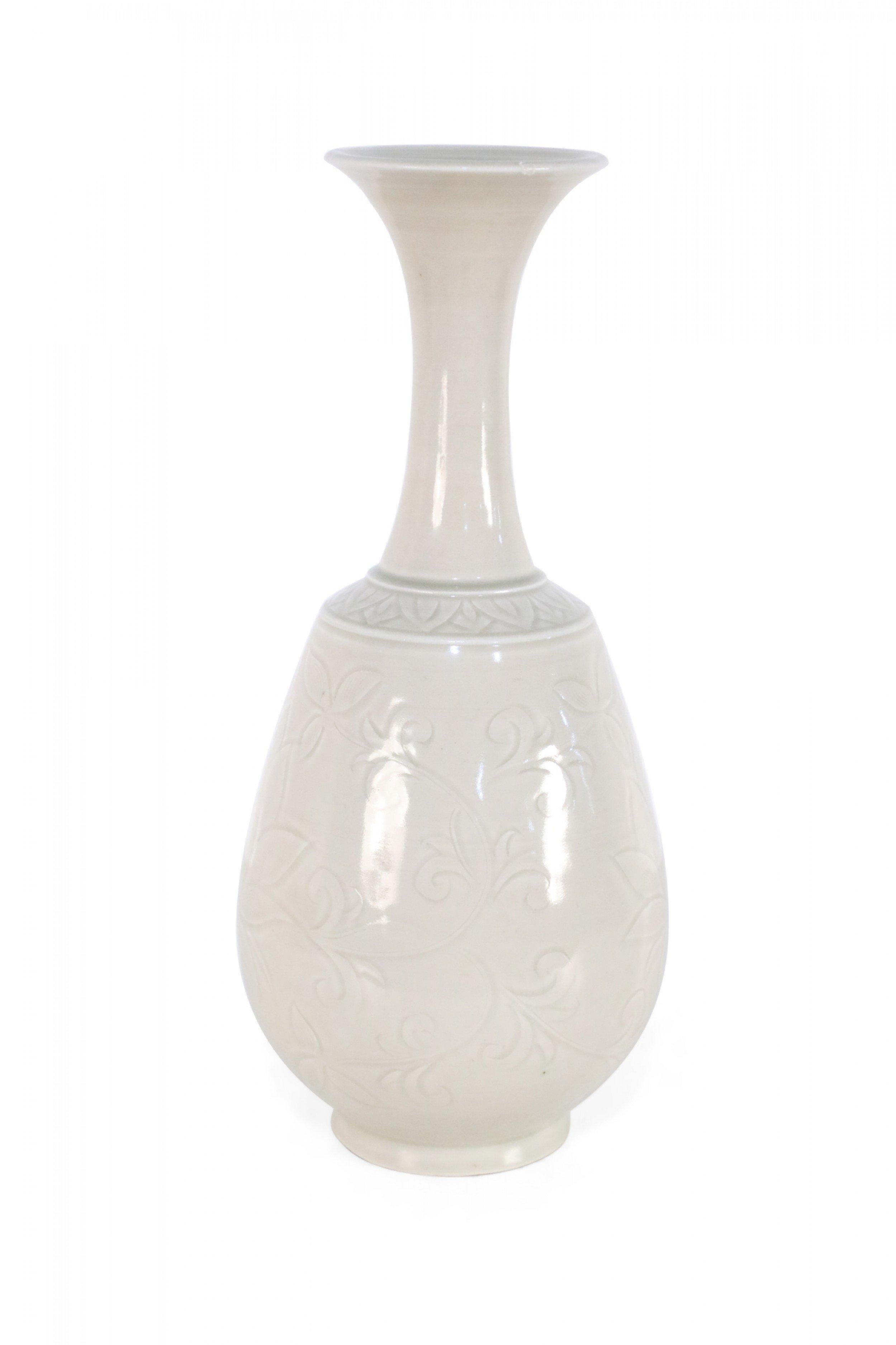 Chinese beige porcelain vase crafted in the style of the Song Dynasty with a thin fluted neck leading to a bulbous bottom decorated in an incised floral pattern. 
    