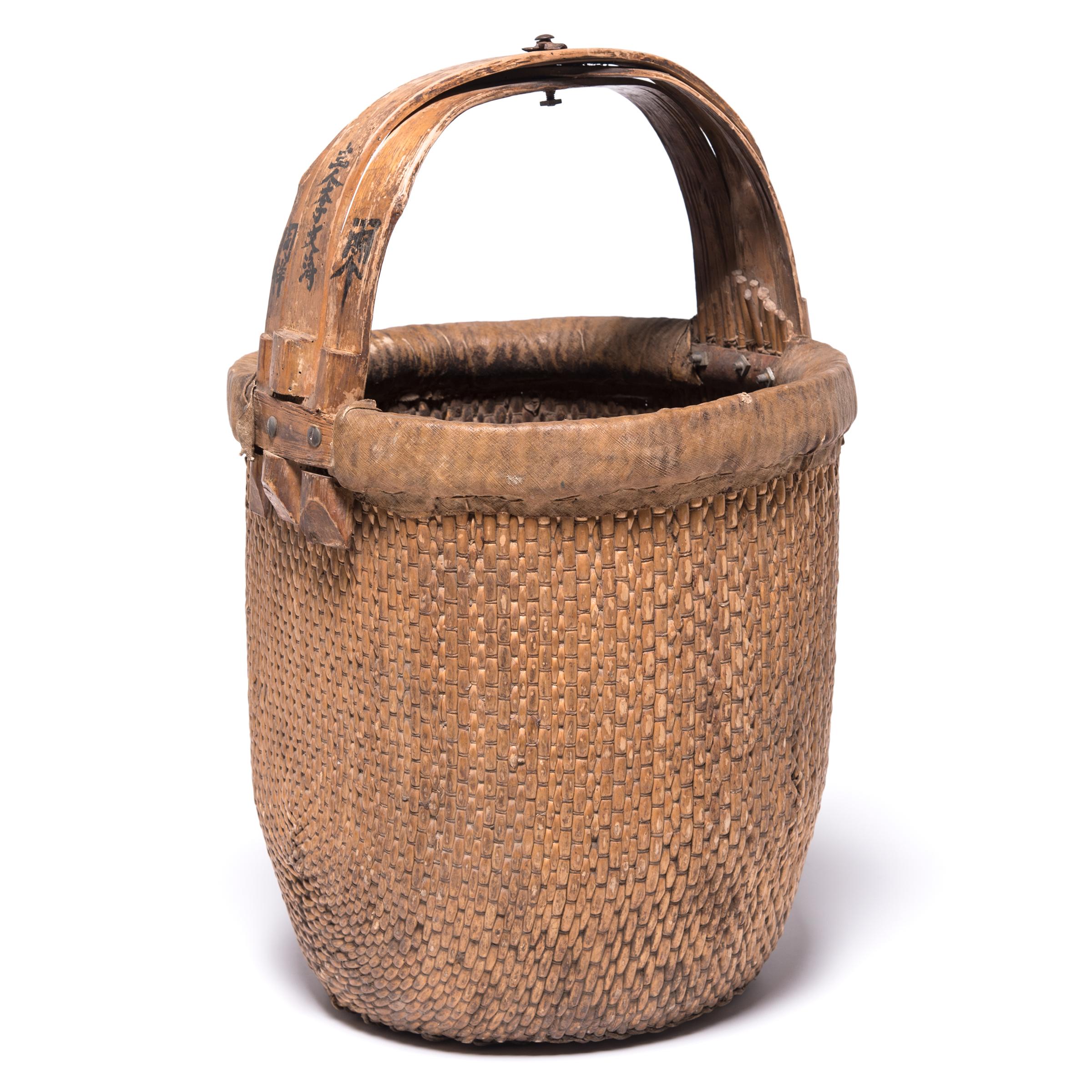Basket making is an ancient and humble craft, but in the hands of a skilled weaver a simple willow basket can become a truly beautiful work of art. This bent handle basket is closely woven of fine willow strips for an evenly textured surface and