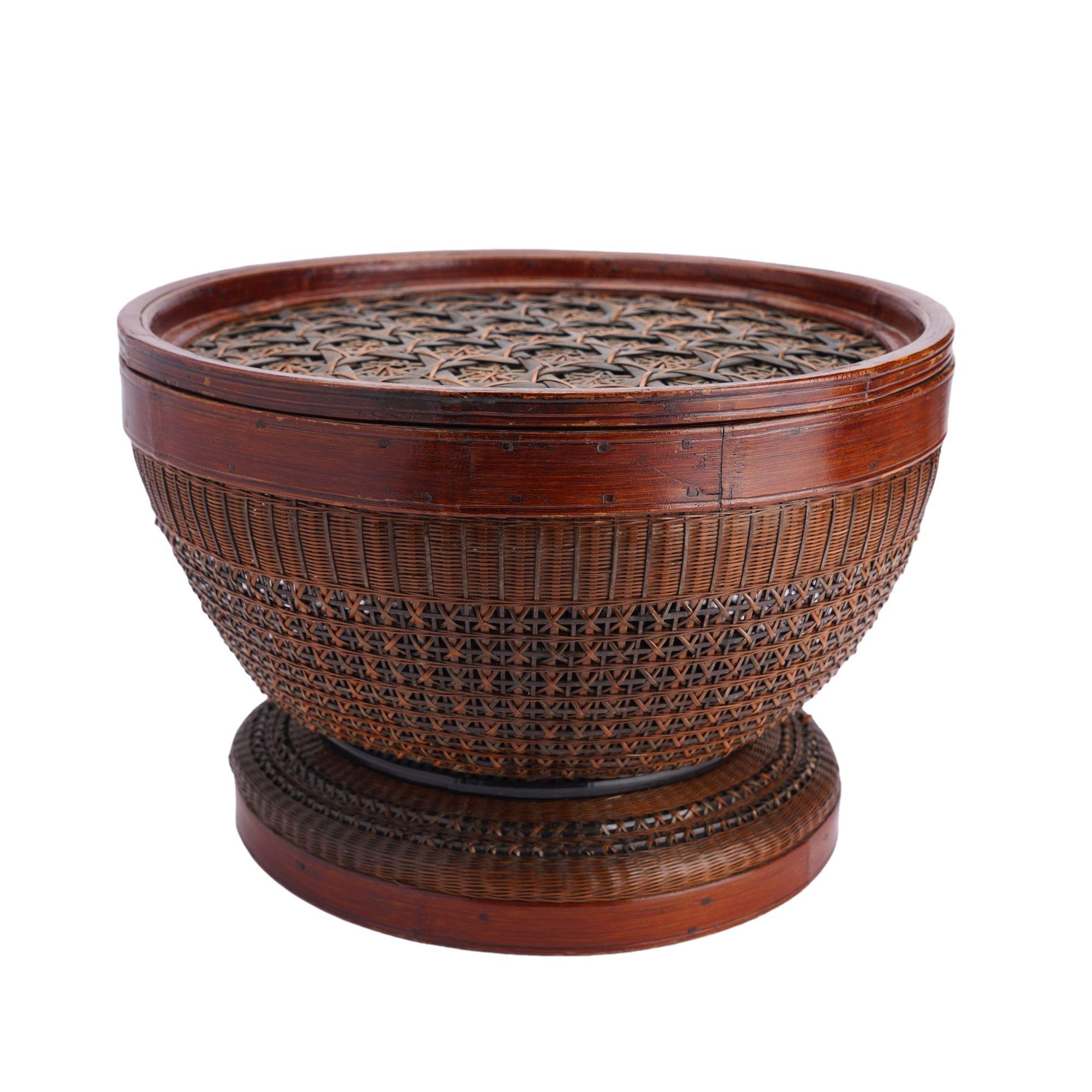 Painstaking hand woven, dyed, and detailed Chinese bamboo betrothal basket with cover. The basket shape is round bowl form on an integrated base, and the thick bamboo rim is fitted with a lid decorated with a layered weaving in the tortoise shell