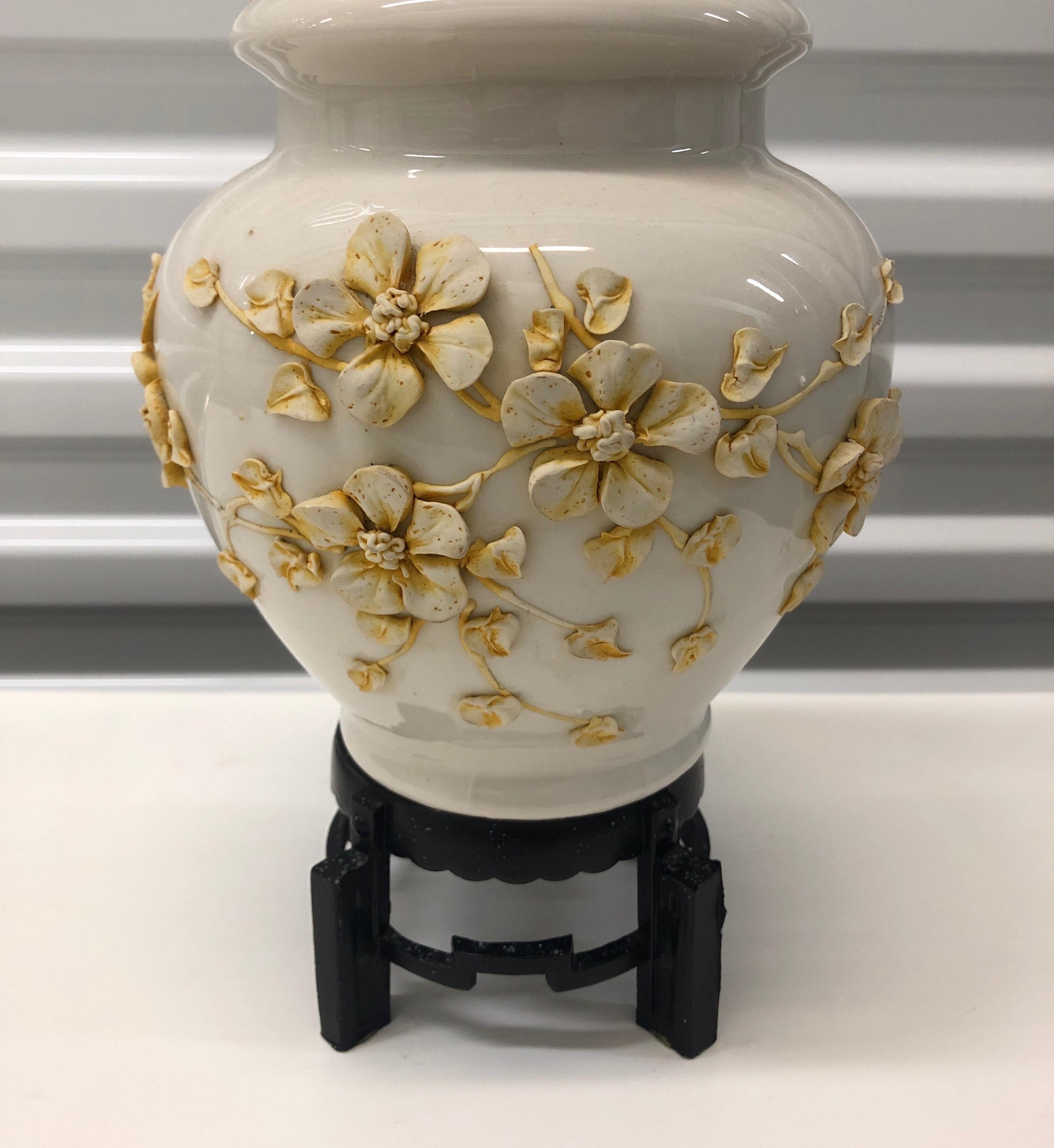 Chinese bisque ceramic lamp.
Floral relief ceramic lamp. Ginger jar shape with traditional Chinese iron base. Brass fittings.
Original ebonized wood finial, 1940s. No lamp shade!
Note: No chips on floral relief. No shade available. Cream color