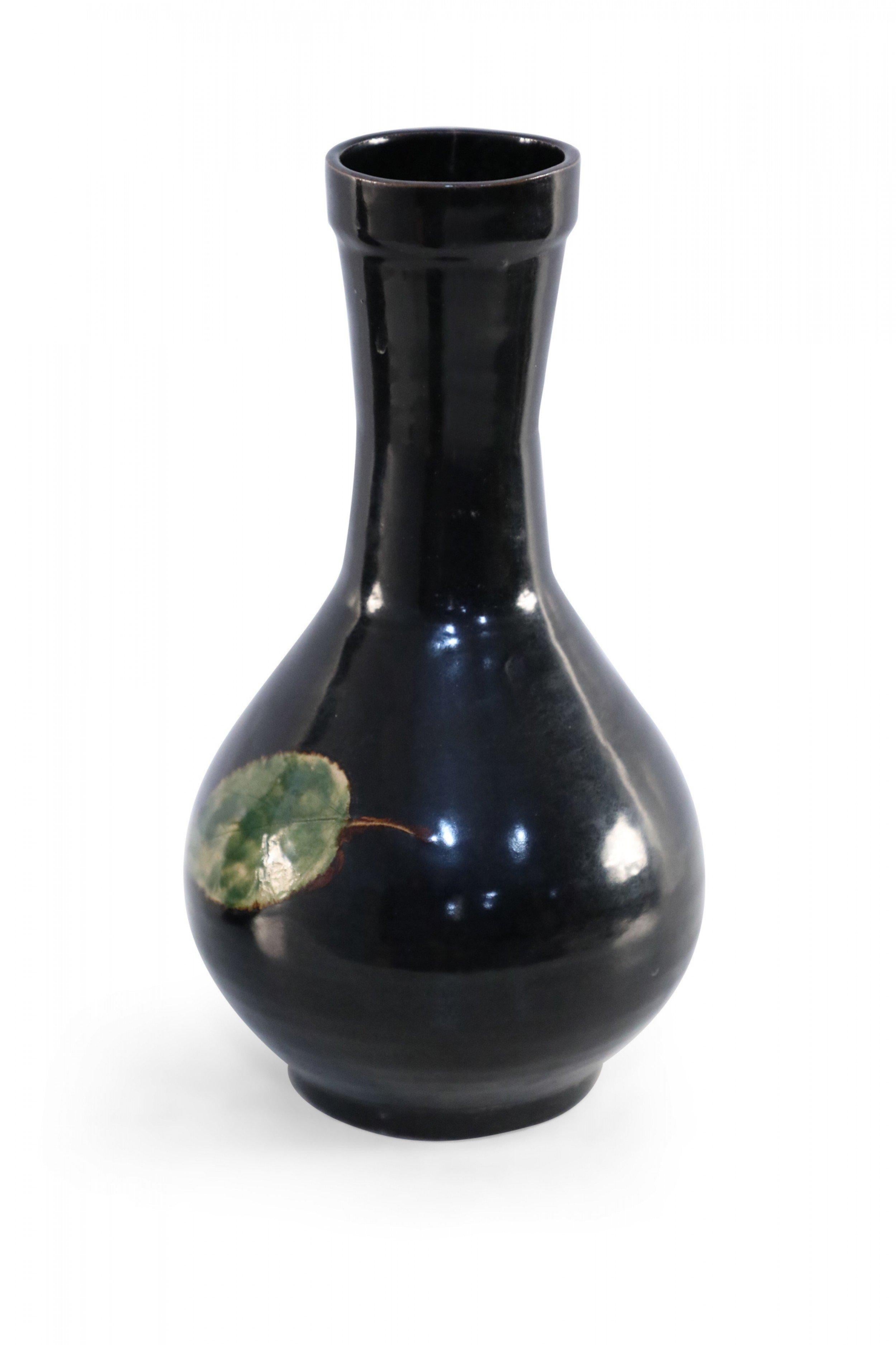 Antike chinesische (17. Jahrhundert) schwarz glasierte kugelförmige Porzellanvase, die auf der Vorder- und Rückseite mit einem grünen Blatt verziert ist. 
 