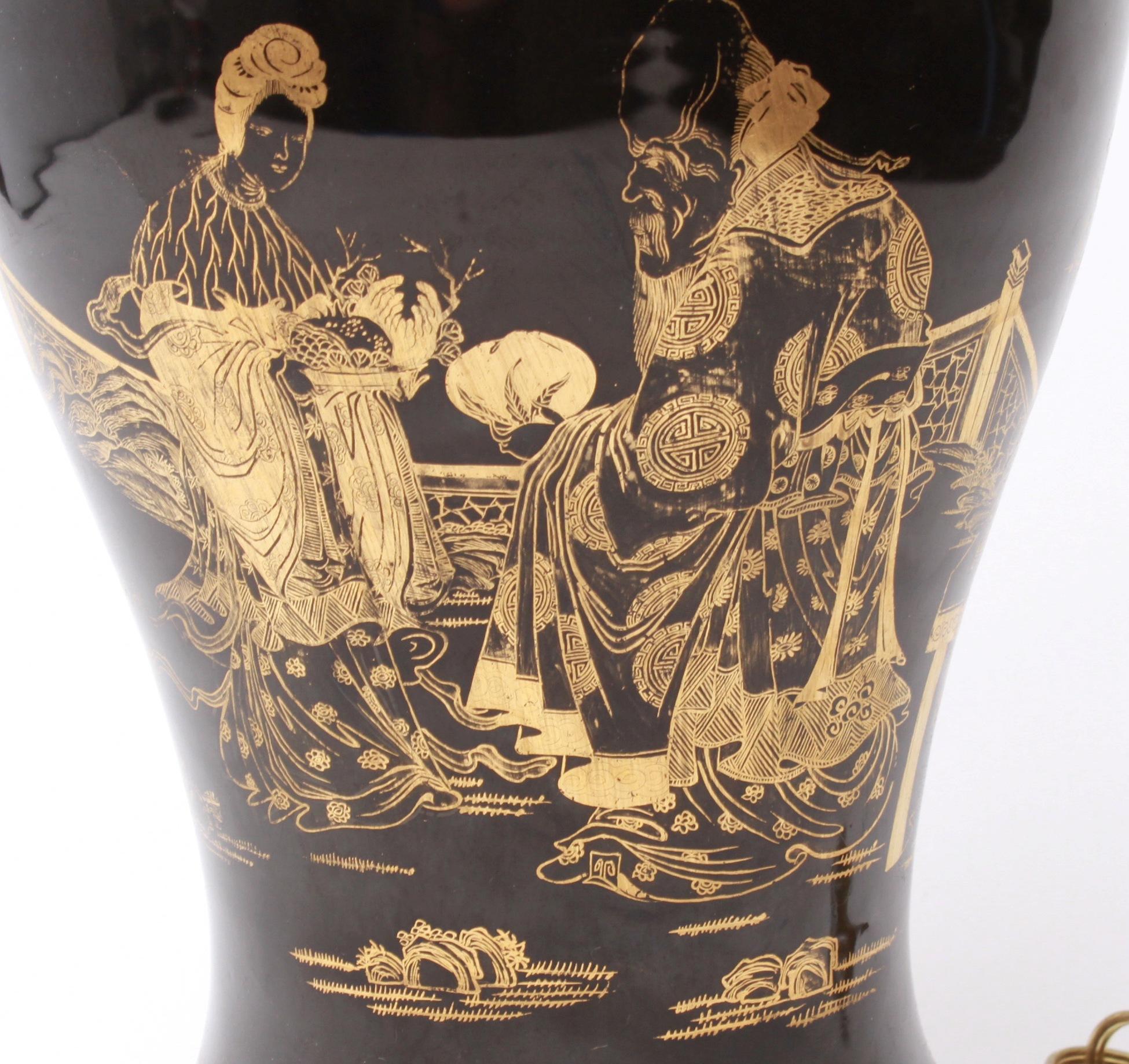 Chinese porcelain vase mounted as a table lamp, with a black glaze with gilt decorations, depicting figural scenes on both sides. In great vintage condition with a minor hairline in the rim.