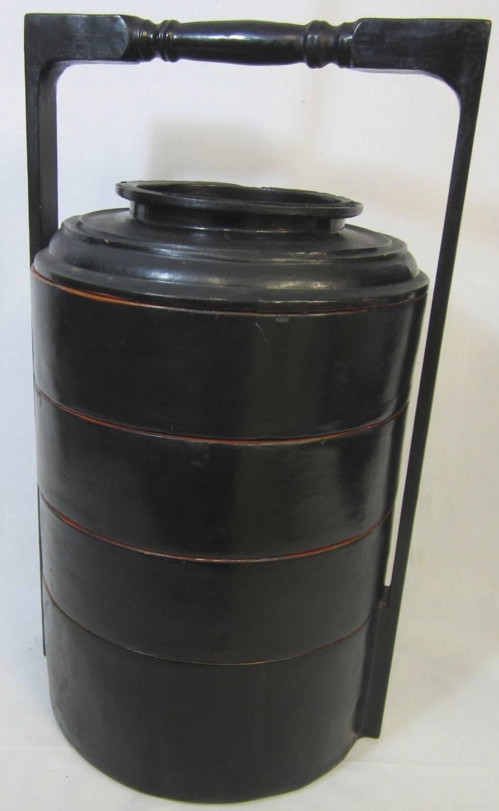 Chinese black lacquer four-tier food basket,
with red lacquer interior, some faults.
