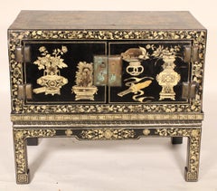 Chinese Black Lacquer and Gilt Decorated Trunk on Stand