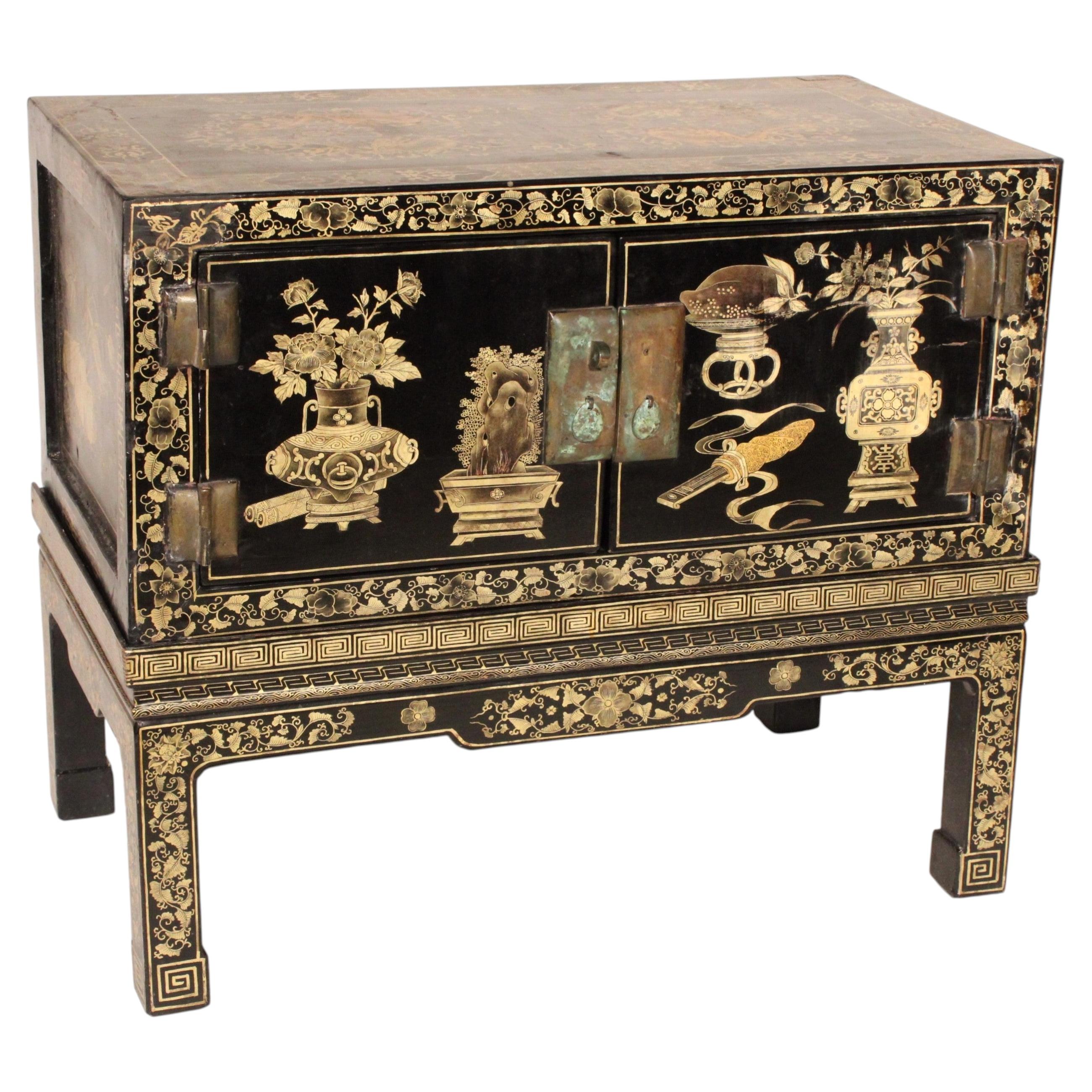 Chinese Black Lacquer and Gilt Decorated Trunk on Stand For Sale