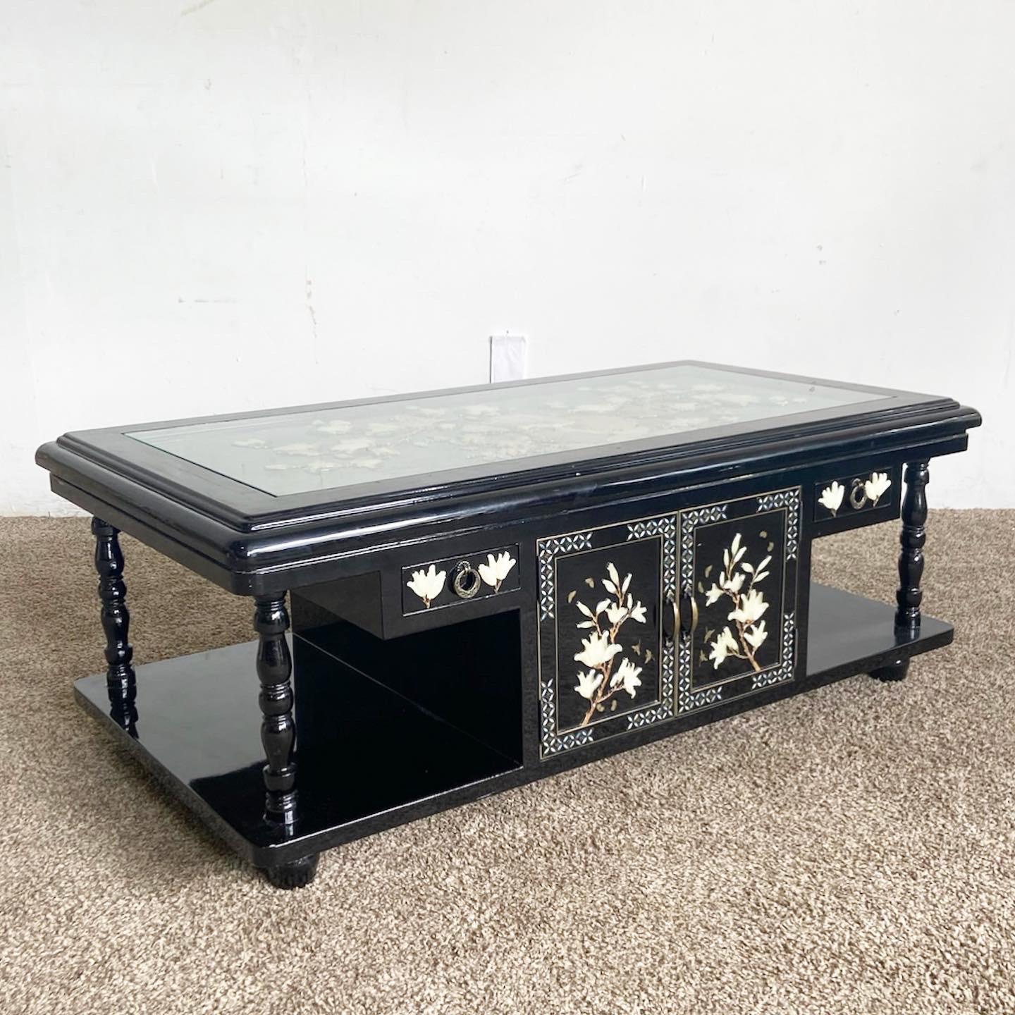 Embrace classic aesthetics with our Chinese Black Lacquer Coffee Table, highlighted by intricate Asian motifs and Mother of Pearl inlays. Featuring a protective inlaid glass top and cabinet doors, this table is a perfect blend of functionality and