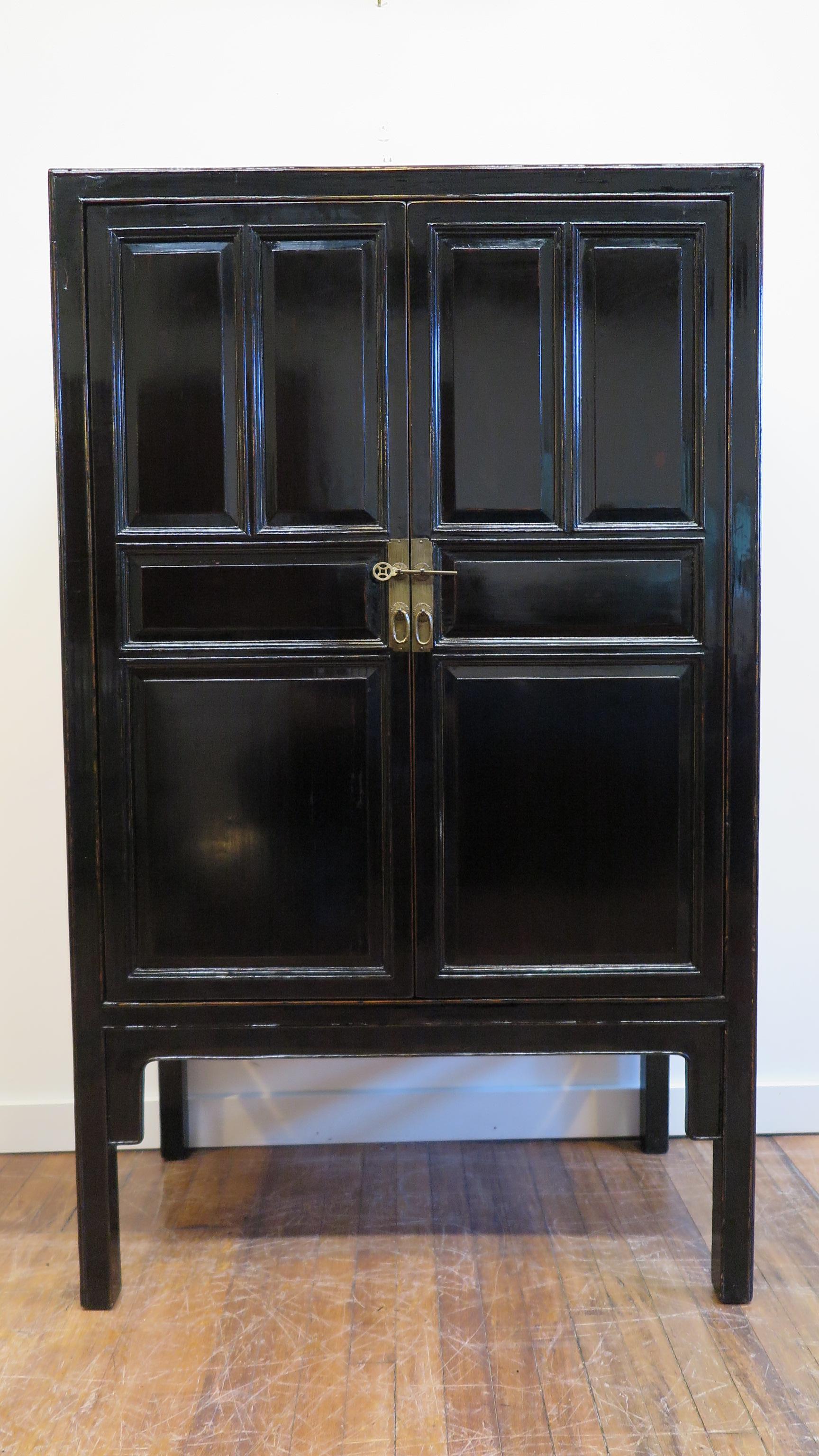 19th century Chinese black lacquer cabinet. A black lacquer Chinese scholars cabinet of cypress wood with black lacquer covering. In very fine condition, excellent, this 19th century Chinese panel cabinet has two drawers with two shelf's upper and