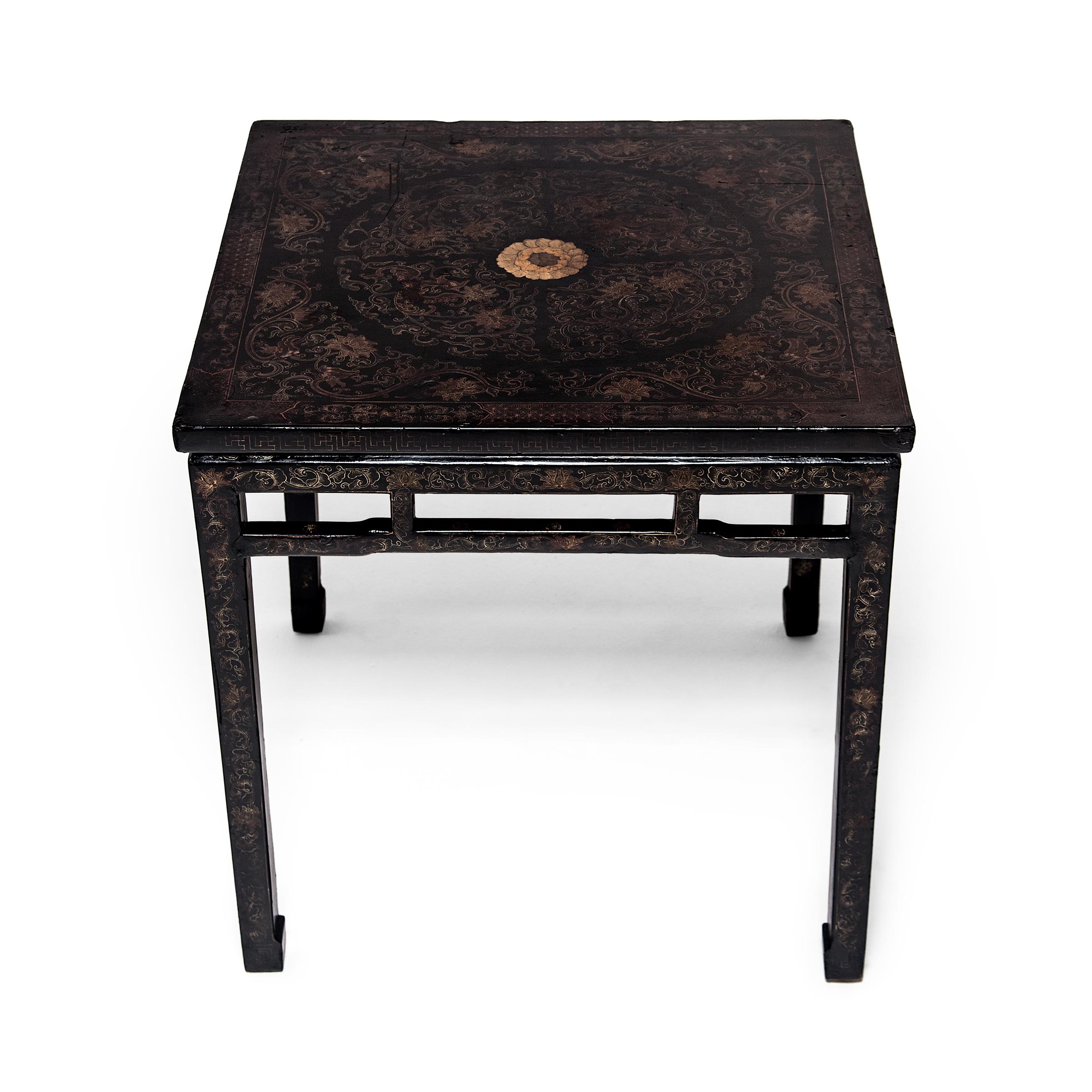 Atop a layer of lustrous black lacquer, intricately painted floral decoration elevates this minimal square table into a work of art. A leafy trailing vines motif winds across the surface, concealing abstract phoenix and dragon forms and framing a