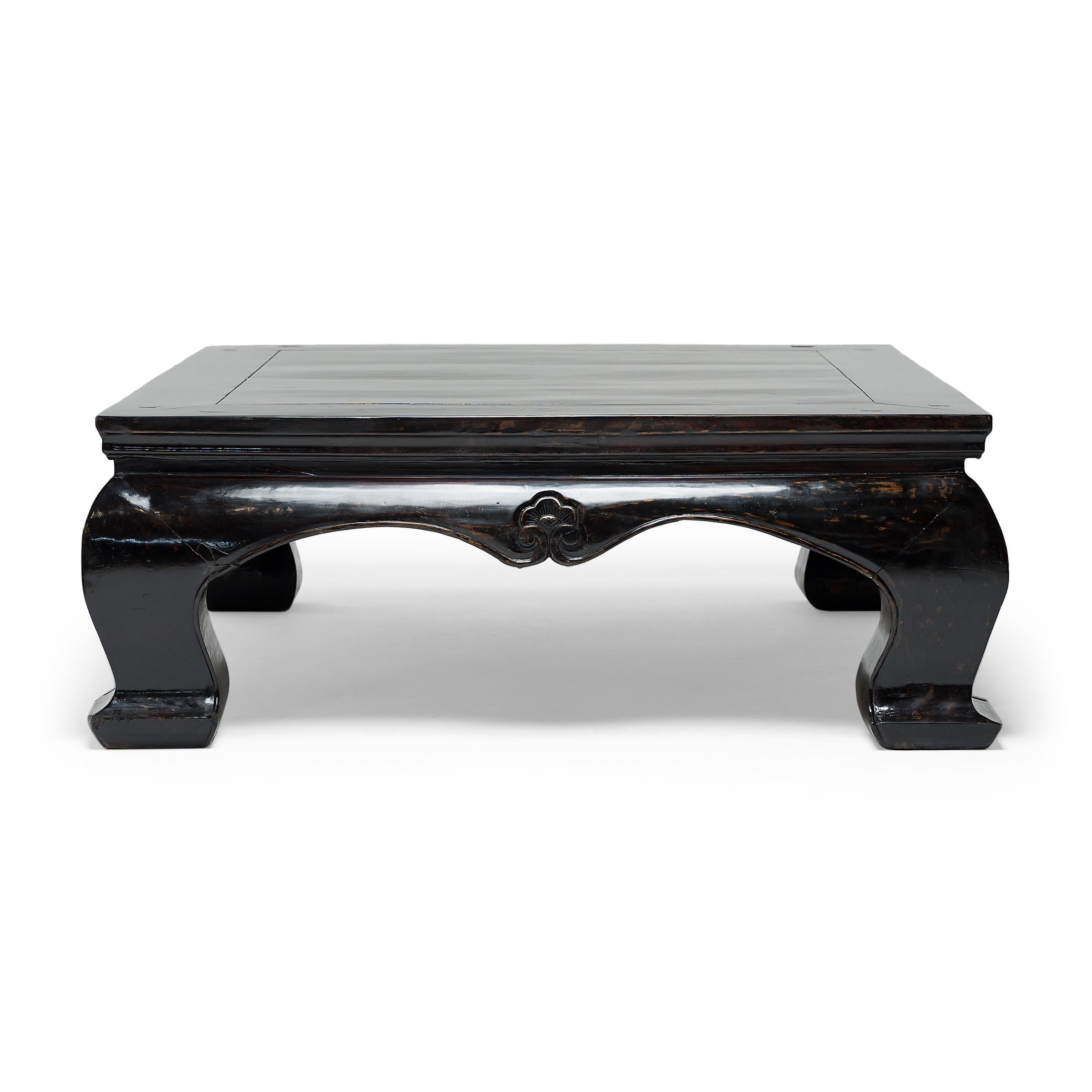 This grand black lacquer table beautifully exemplifies the unique forms of classical Chinese furniture. Constructed in the mid-19th century using traditional joinery methods, the table features a square floating-panel top, a curved waisted apron,