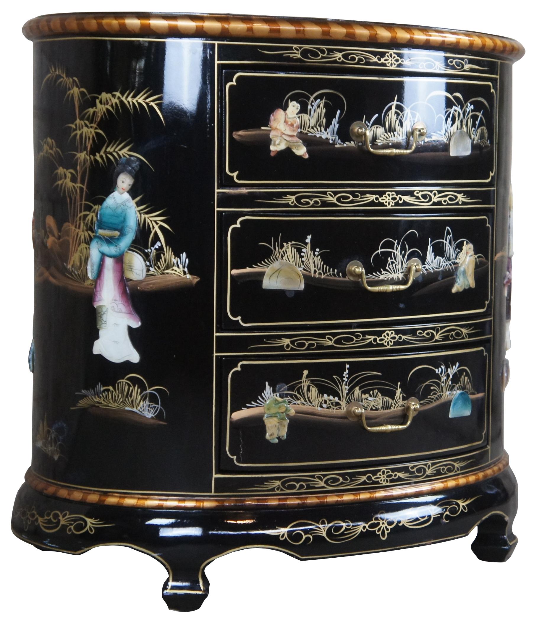 Vintage oriental black lacquered side table featuring three drawers and soapstone carved geishas with floral accents.
 