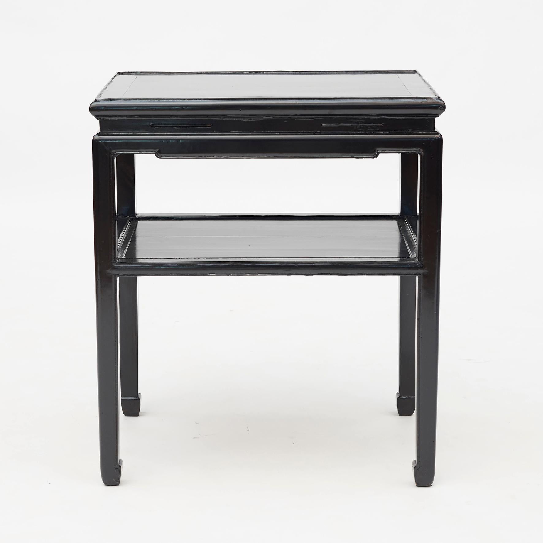 A beautiful Chinese walnut with black lacquer side table from the early-20th century. Four square legs, united by an under tier shelf. Elegant finish on top and shelf Shanghai, China, circa 1920.
      
