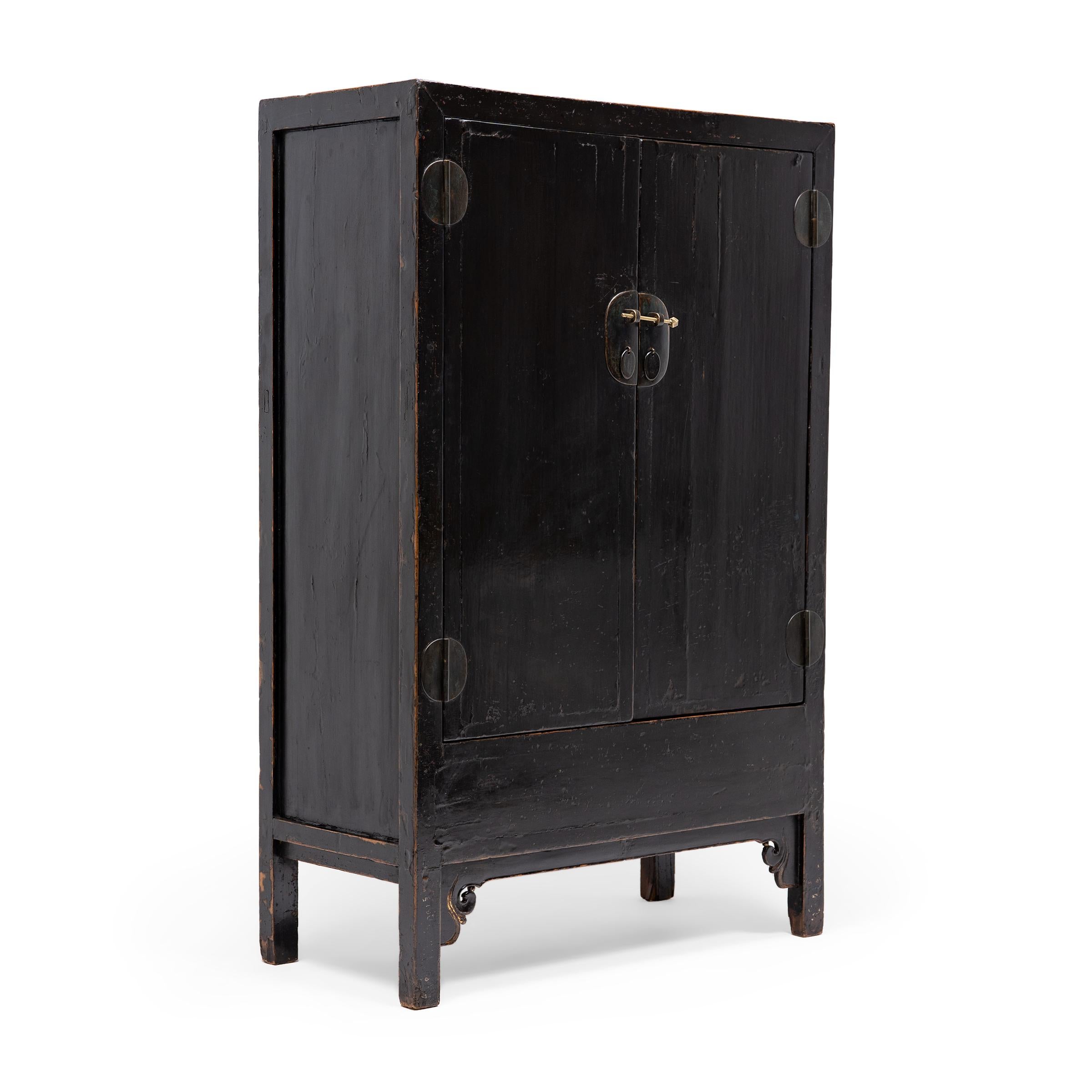With clean lines and a darkly lacquered finish, this square corner cabinet celebrates the restraint of classic Chinese furniture forms. Dated to the mid-19th century, the tall cabinet is crafted of elmwood with traditional mortise-and-tenon joinery