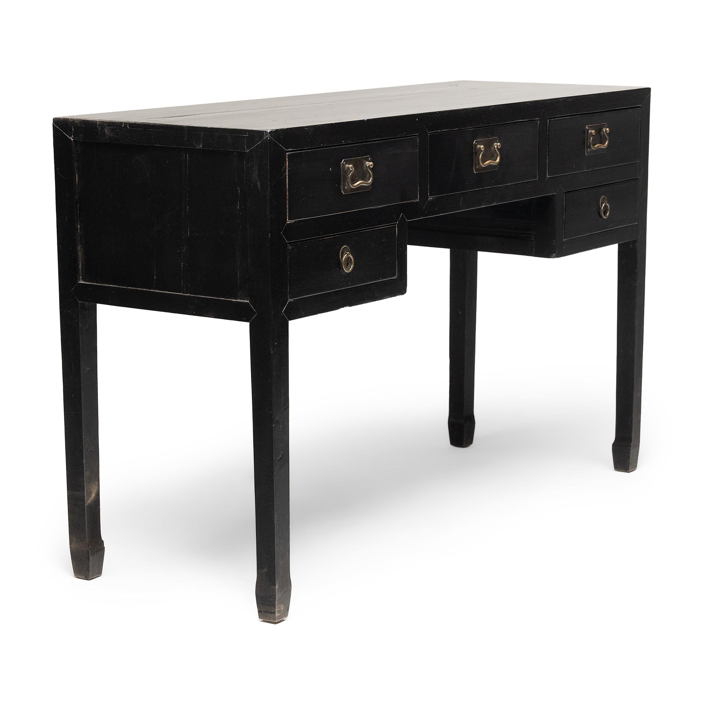 This five-drawer writing desk from the early 20th century has a timeless simplicity, designed with clean-lines and an even, black lacquer finish. Crafted of northern elm (yumu), the desk features straight corner legs ending in hoof feet and provides
