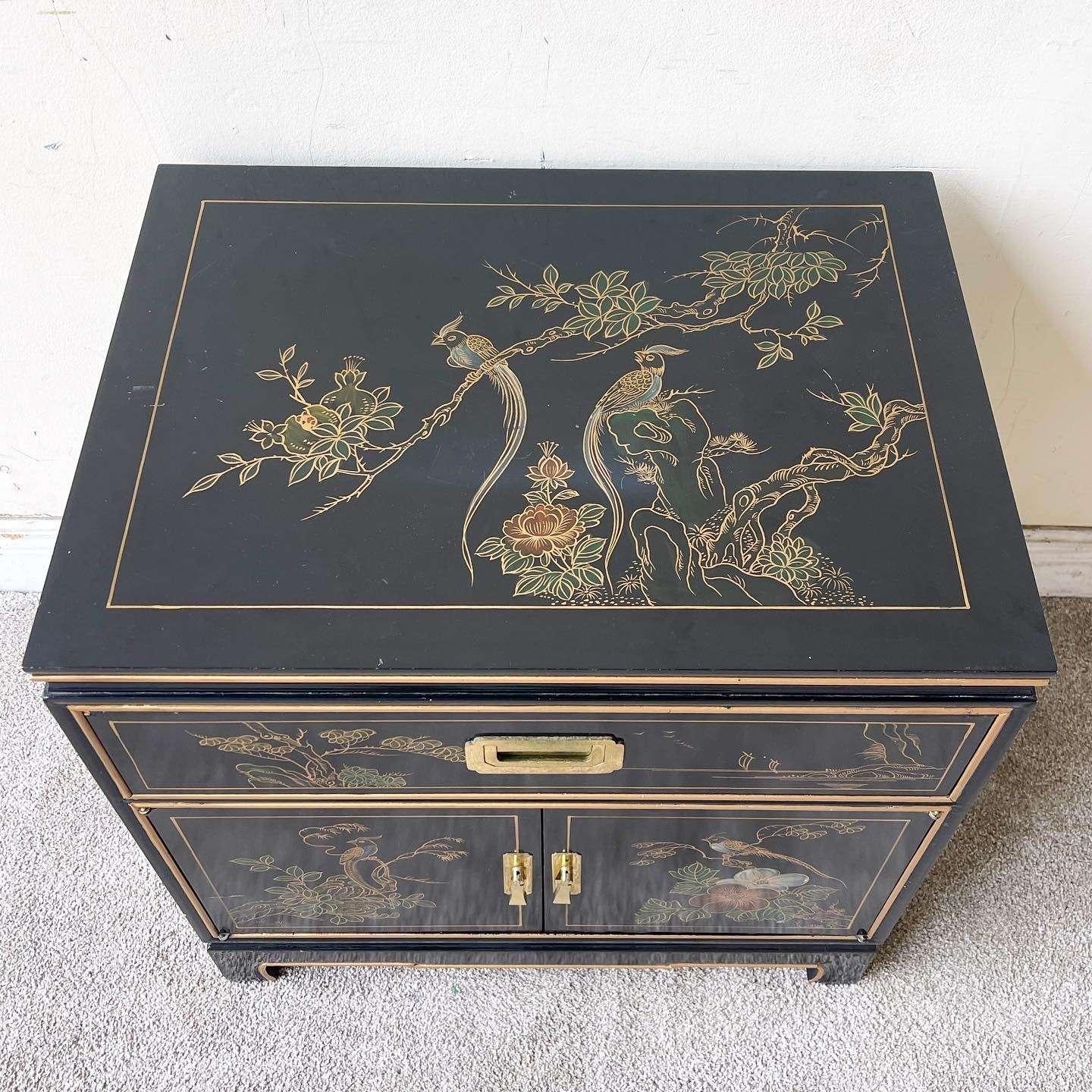 Amazing vintage Chinese end table/nightstand. Features a black lacquered finish with gold accents and brass handles.

