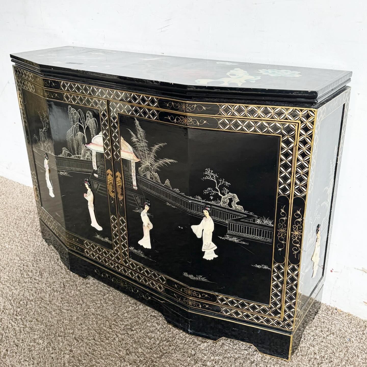 Immerse yourself in the splendor of a Chinese Black Lacquered and Hand Painted Sideboard, enriched with bone stone accents. This luxurious piece showcases the beauty of traditional Chinese art through its detailed hand-painted scenes and motifs, set