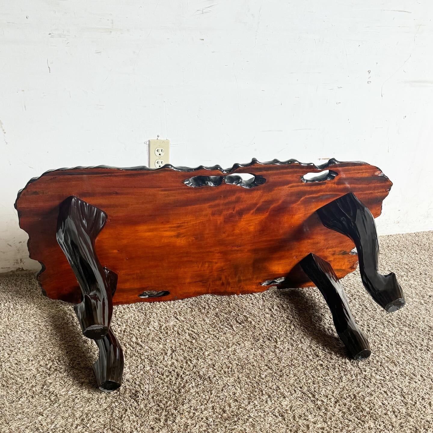 Add a touch of asian elegance to your living space with this Chinese Black Lacquered Coffee Table. Hand-painted with intricate motifs and adorned with delicate mother of pearl inlay, this table showcases traditional Asian craftsmanship. The sleek