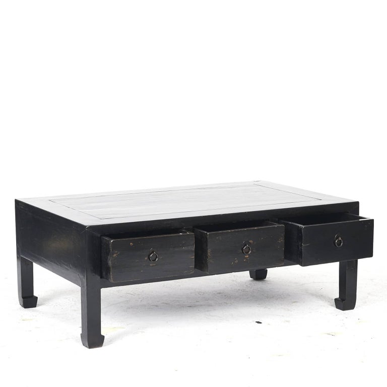 Chinese Art Deco coffee table in elm with original black lacquer.
This low table features a rectangular top sitting above three drawers fitted with ring pulls on circular backplates.

Created in China, from the Hebei Province, 1910-1920.
 