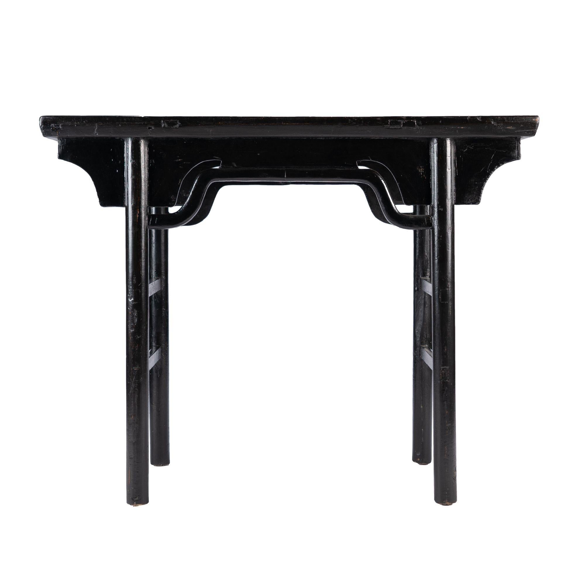 Black lacquered elm wood wine table with articulated hump back “bridge” apron rail.
Chinese, Kuang Hsu Period, circa 1875.