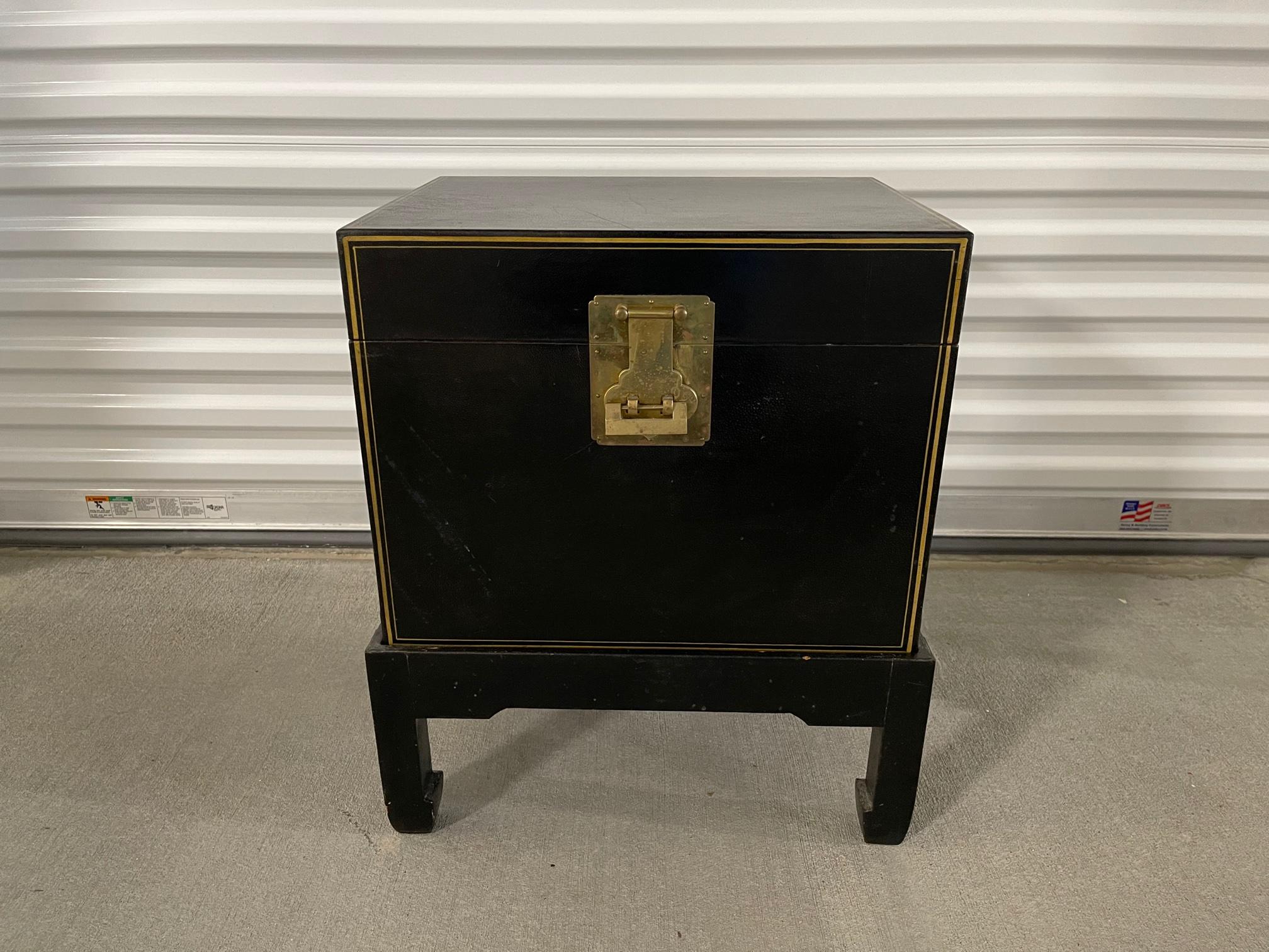Chinese black leather trunk on stand with brass lock and handles, 20th century.

The height of the stand is 8.25”.