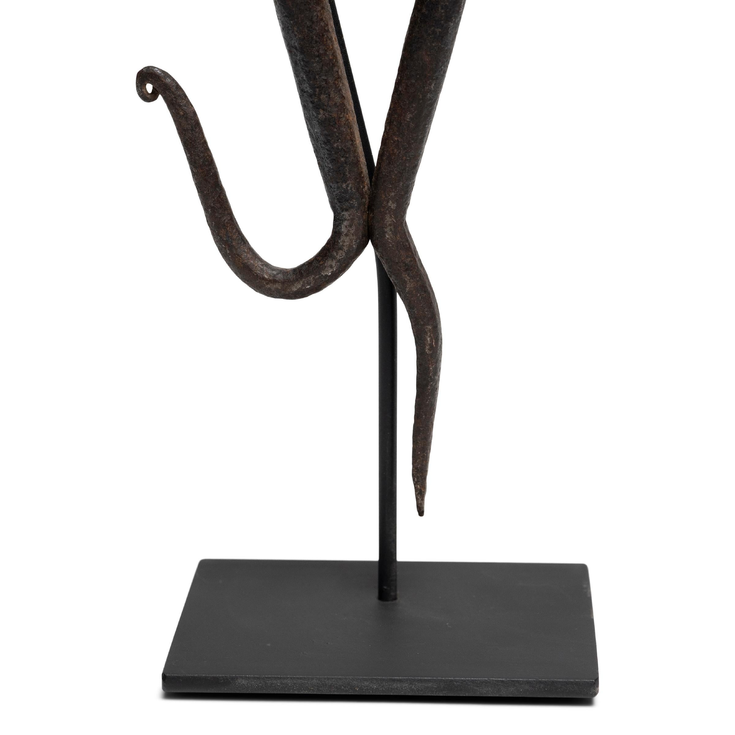 This hand-forged metal sculpture, with its delicate appearance and whimsical shape, was once an integral tool to a 19th century Chinese cobbler’s trade. Made of iron, these scissors were fashioned in a way to effectively cut and shape leather,