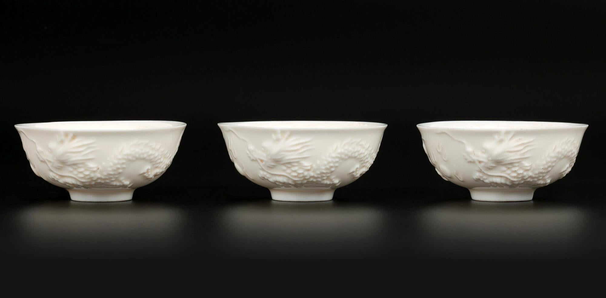 18th Century and Earlier Chinese Blanc de Chine Dueling Dragon Molded Tea Bowls For Sale
