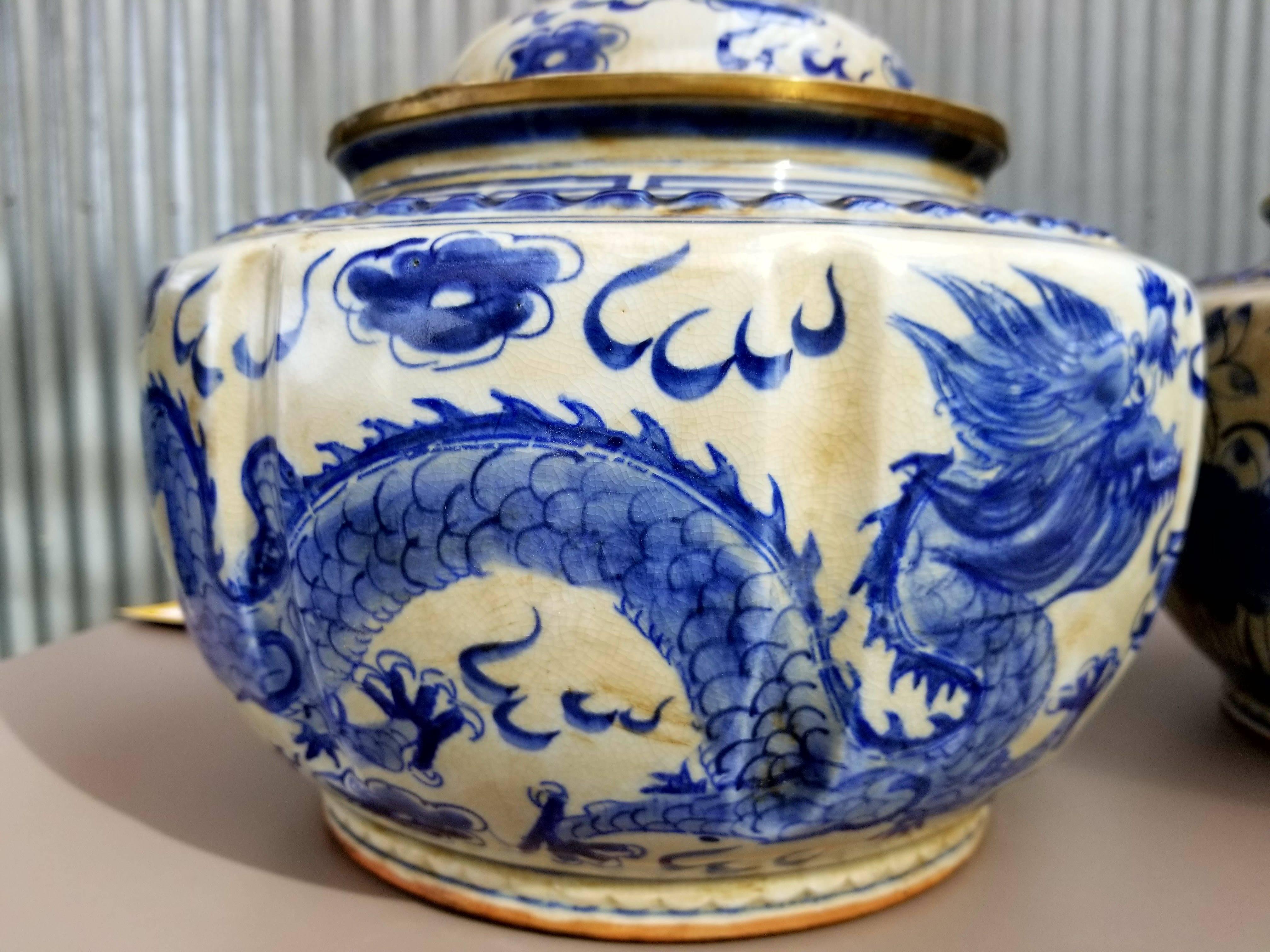 A pair of hand painted Chinese porcelain ginger jars. Depicting a dragon and fish.