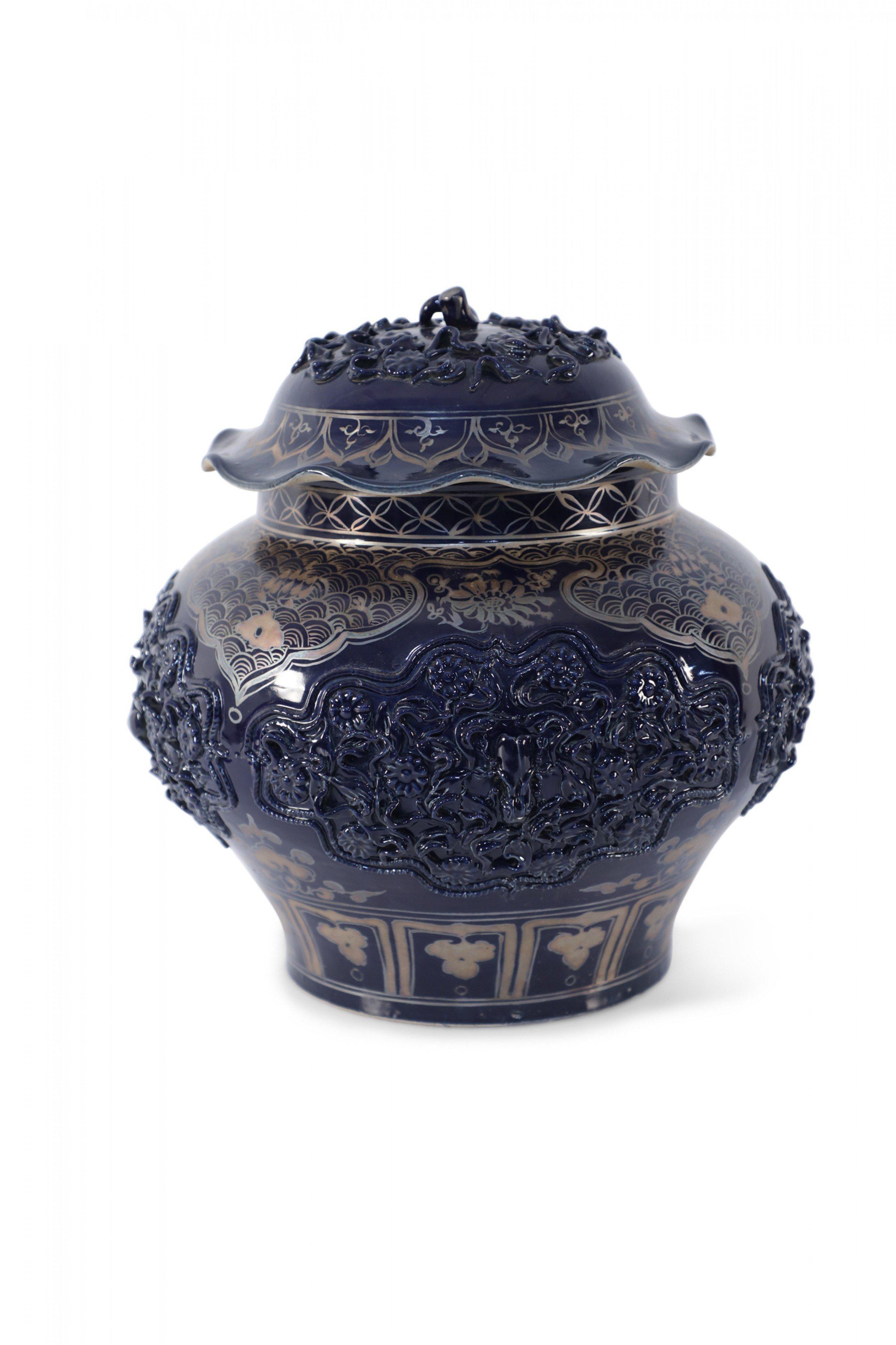 Vintage Chinese dark blue porcelain pot decorated with a combination of intricate gold painting and raised medallions of florals, each with a beetle in the center, and a stem emerging from the top of the lid.

One beetle is broken, damage to base.