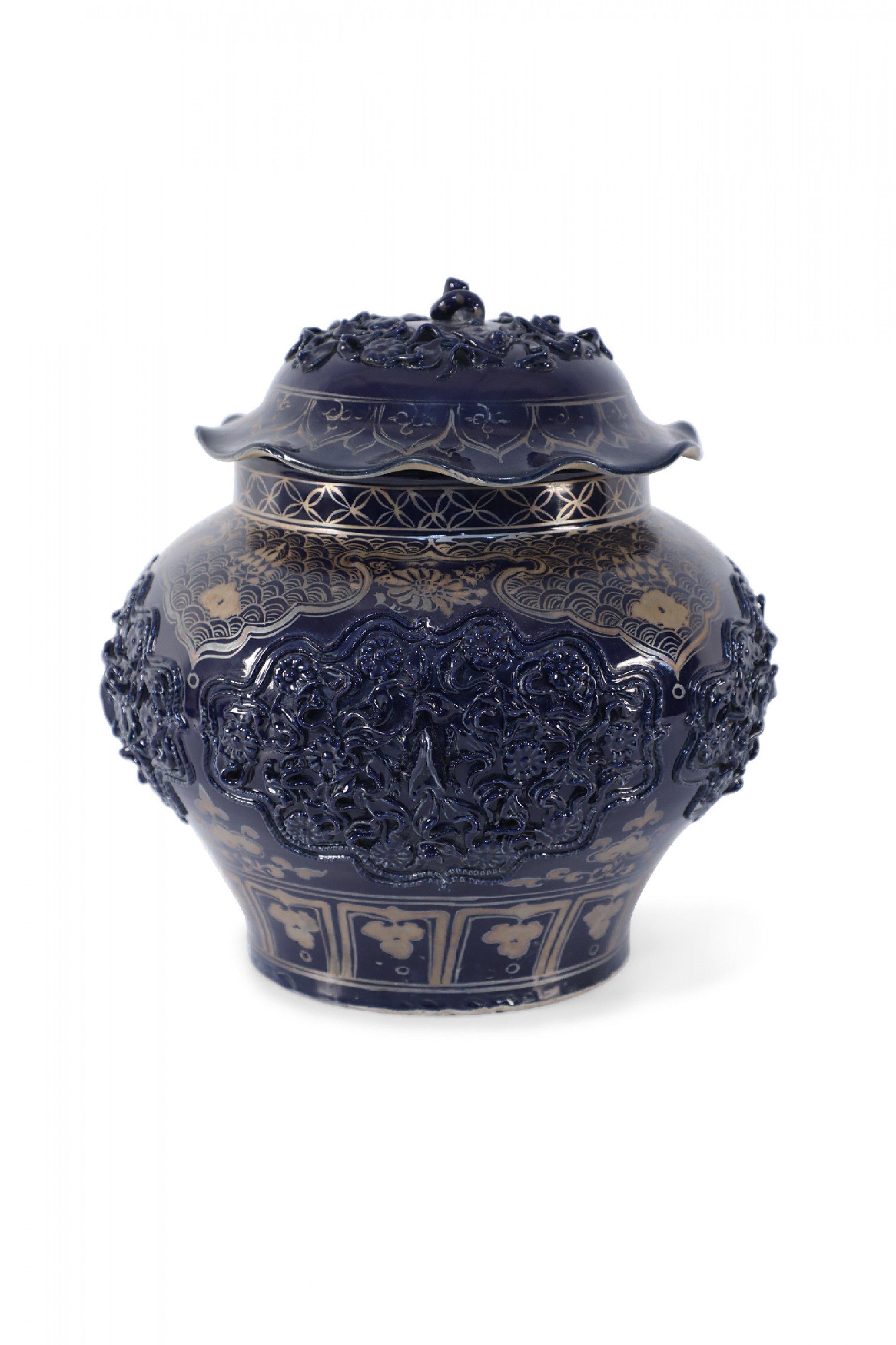 Vintage Chinese dark blue porcelain pot decorated with a combination of intricate gold painting and raised medallions of florals, each with a beetle in the center, and a stem emerging from the top of the lid.