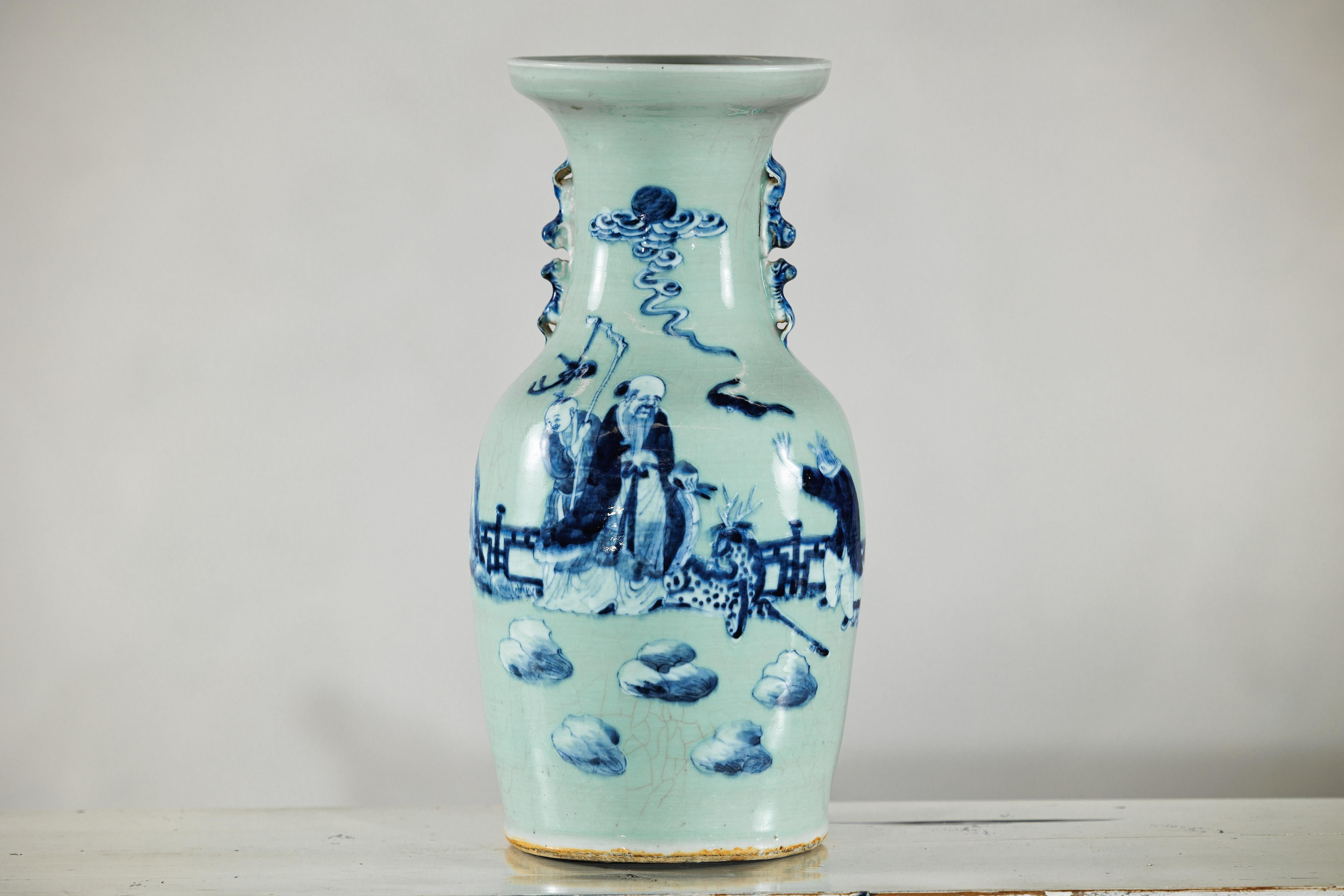A tall and finely potted Chinese porcelain altar vase, decorated in underglaze cobalt blue on a pale celadon ground. Standing 17 inches high with an 8.5-inch body diameter and a wide 7-inch mouth opening, the vase displays a balanced, slightly