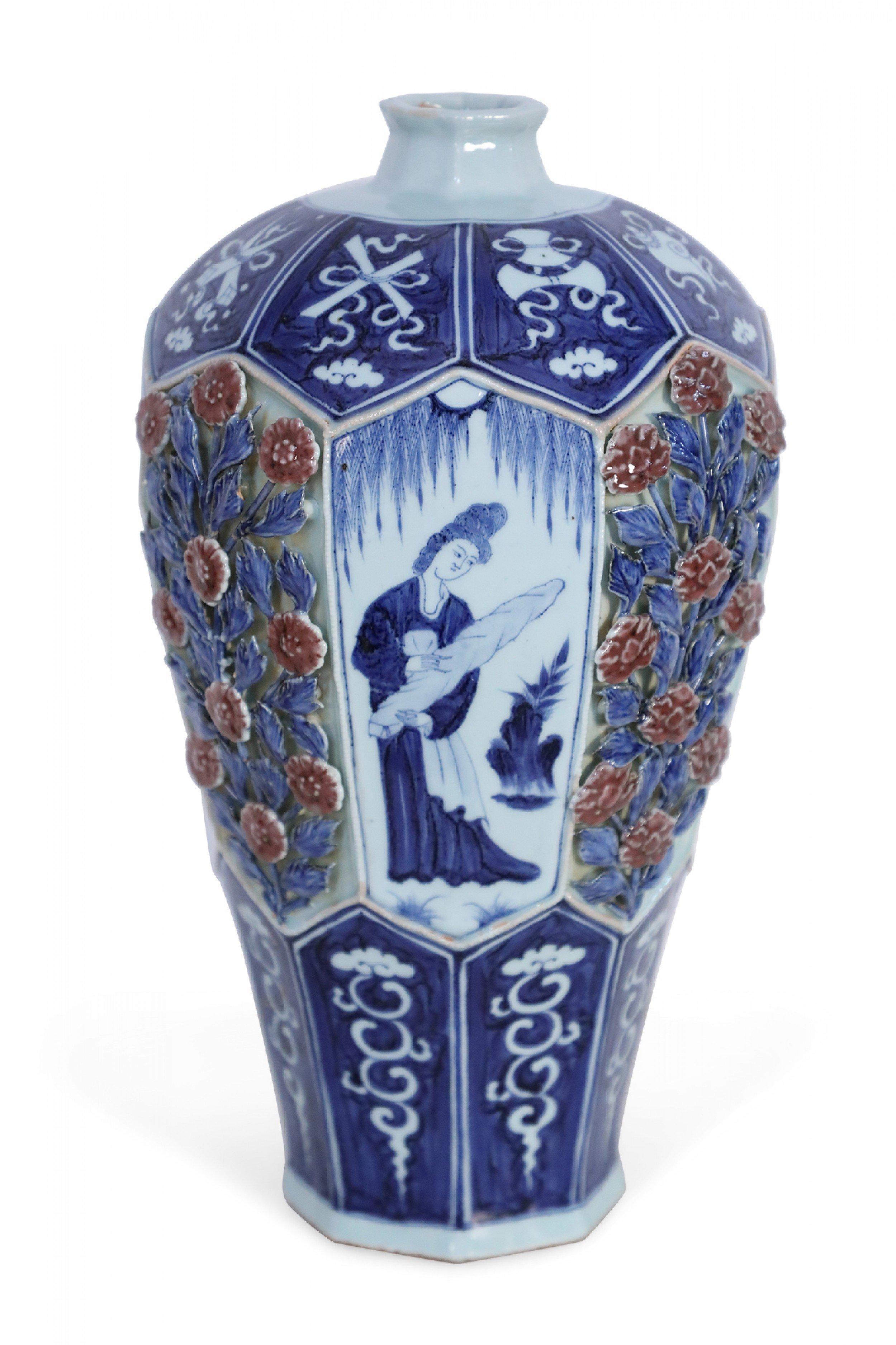 Chinese blue and white porcelain vase with an octagonal, faceted shape wrapped in blue bands featuring white iconography at the base and convex top, framing a center area that alternates figurative vignette panels with raised, pierced roses amid