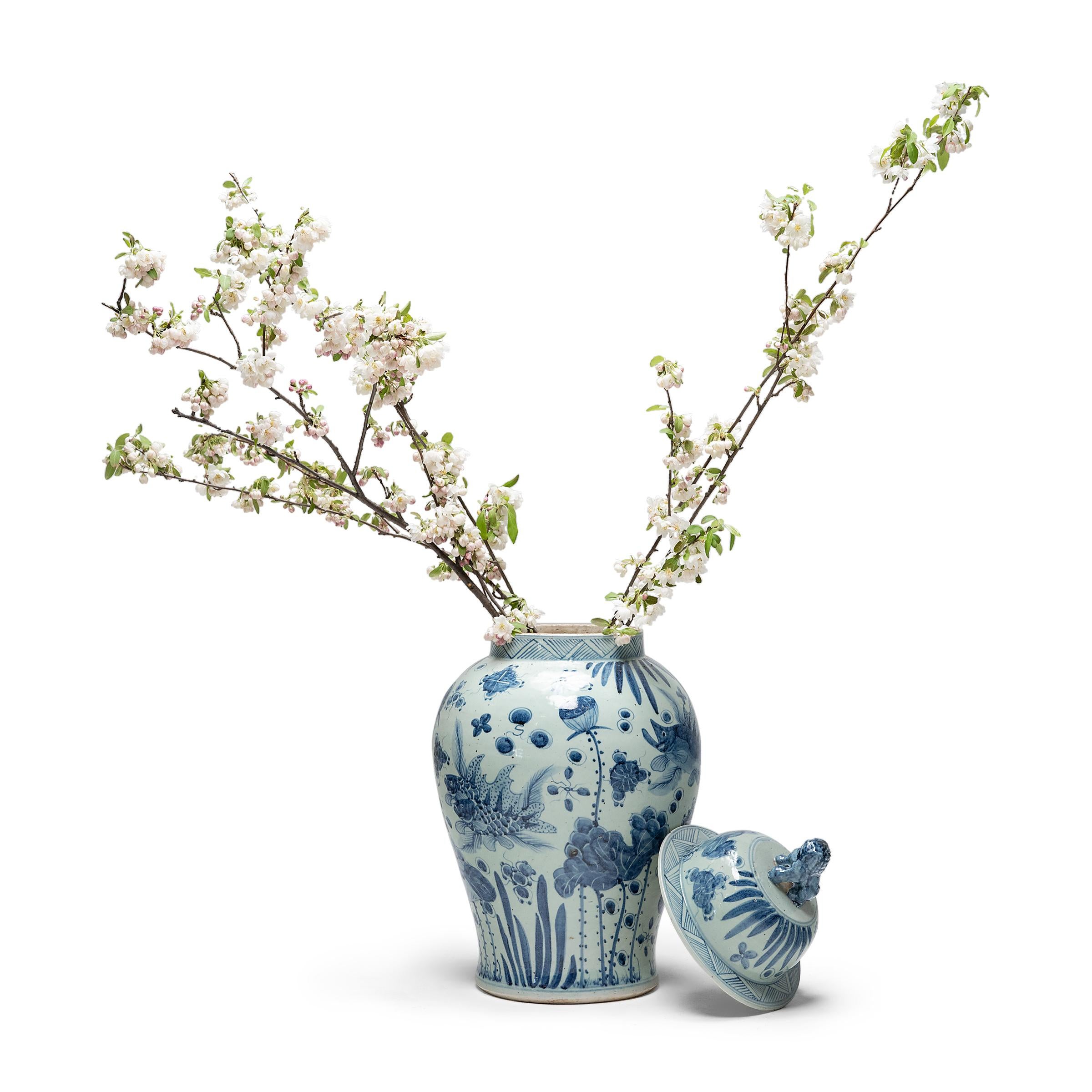 This blue-and-white covered jar is hand-painted with flora and fauna of the sea, offering blessings of wealth, abundance, and the contented harmony of a fish in water. Chinese blue-and-white ceramics have inspired ceramists worldwide since cobalt