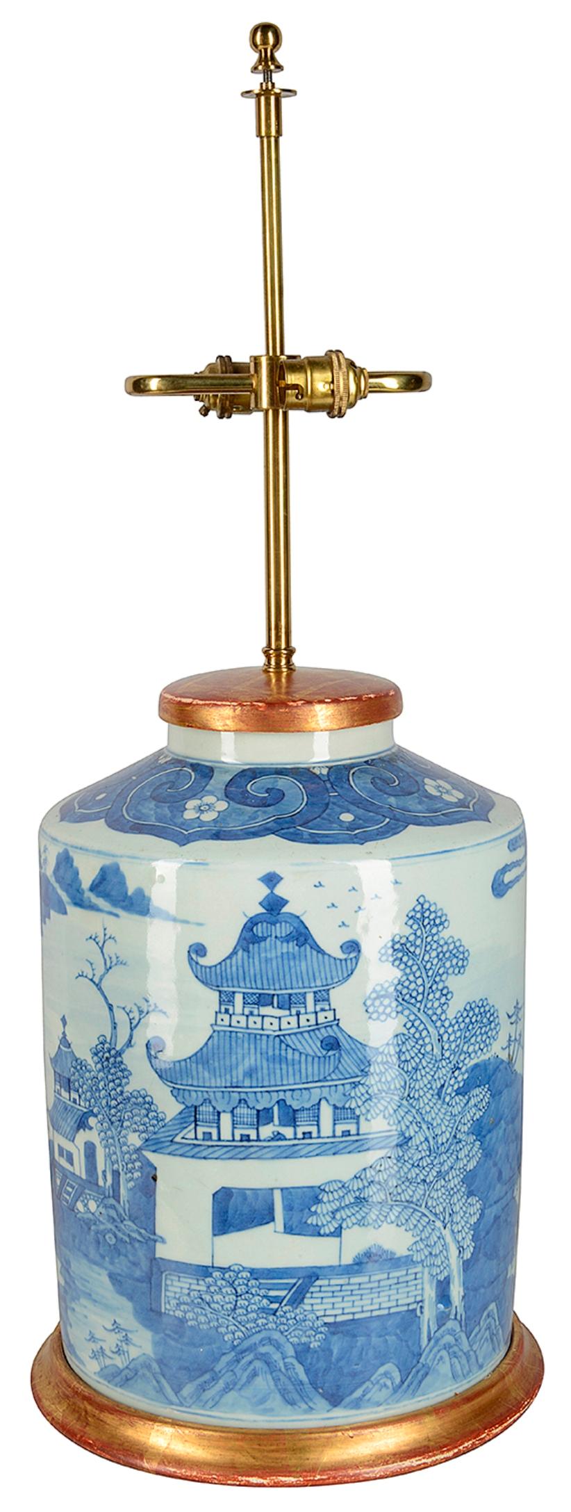 A very impressive late 19th century Chinese blue and white porcelain jar / lamp. Having classical pagoda buildings set into gardens and mountains behind. Mounted on a gilded base and lid.