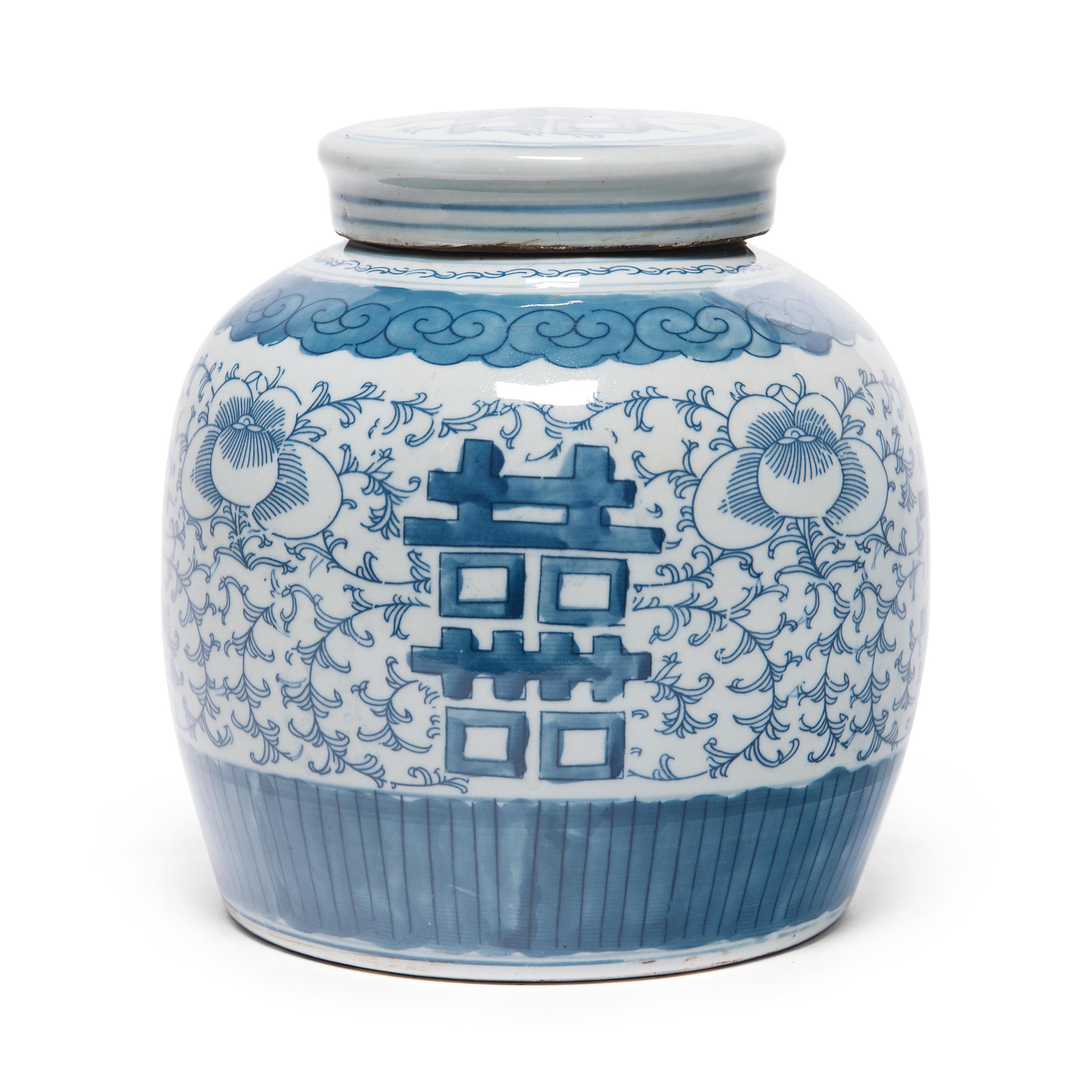 Glazed in the classic blue-and-white manner, this rounded jar offers a blessing of happiness and good fortune. Painted on either side of the jar is the symbol for 